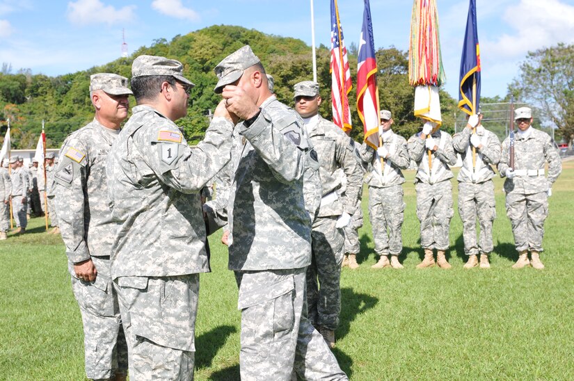Command Sgt. Maj. Rene A. Berlingieri relinquishes responsibility to Command Sgt. Maj. Jose E. Nieves during the 166th Regional Support Group Change of Responsibility Ceremony, January 31 at the Maxi Williams Field, Fort Buchanan, Puerto Rico.