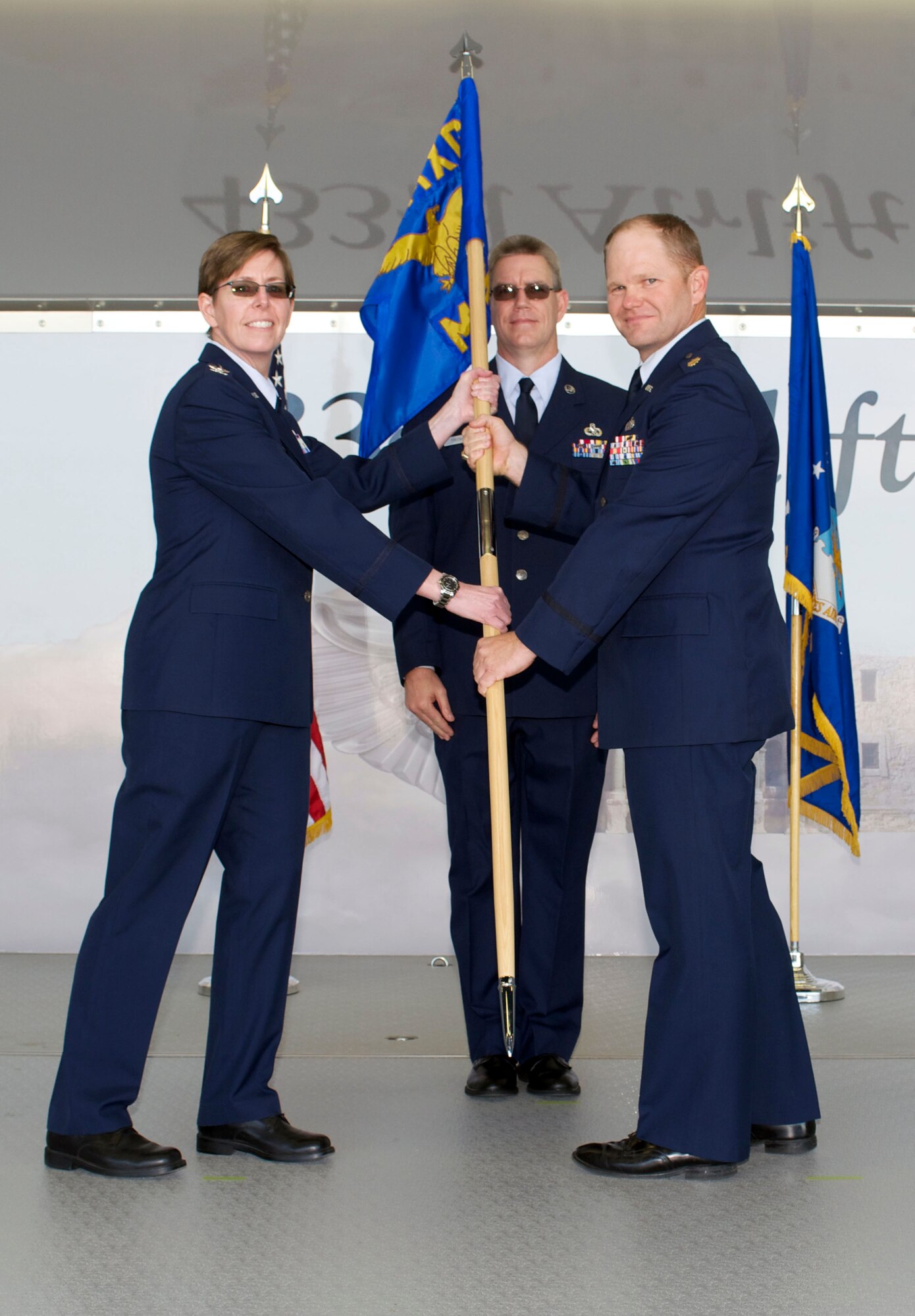 Maj. A. Spence Pennington, assumes command of the 433rd Maintenance Squadron from Col. Gretchen M. Wiltse, 433rd Maintenance Group, during a ceremony Jan. 30, 2016 at Joint Base San Antonio-Lackland. (U.S. Air Force photo by Tech. Sgt. Lindsey Maurice)