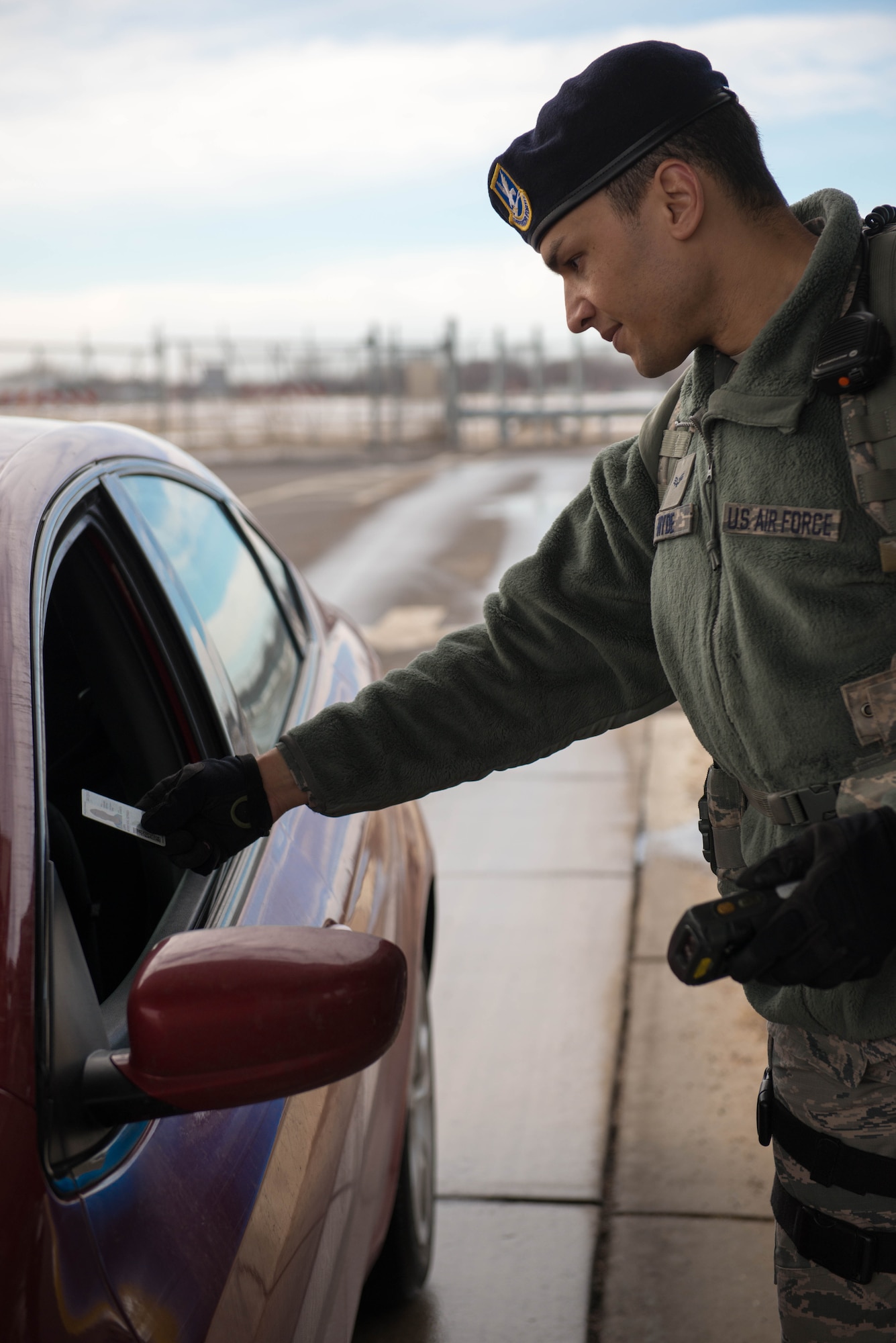 Senior Airman Branham Hyde, of the 934th Security Forces Squadron, checks an I.D. card at the main gate of the Minneapolis-St. Paul Air Reserve Station Jan. 31 (U.S. Air Force Photo by Staff Sgt. Trevor Saylor)