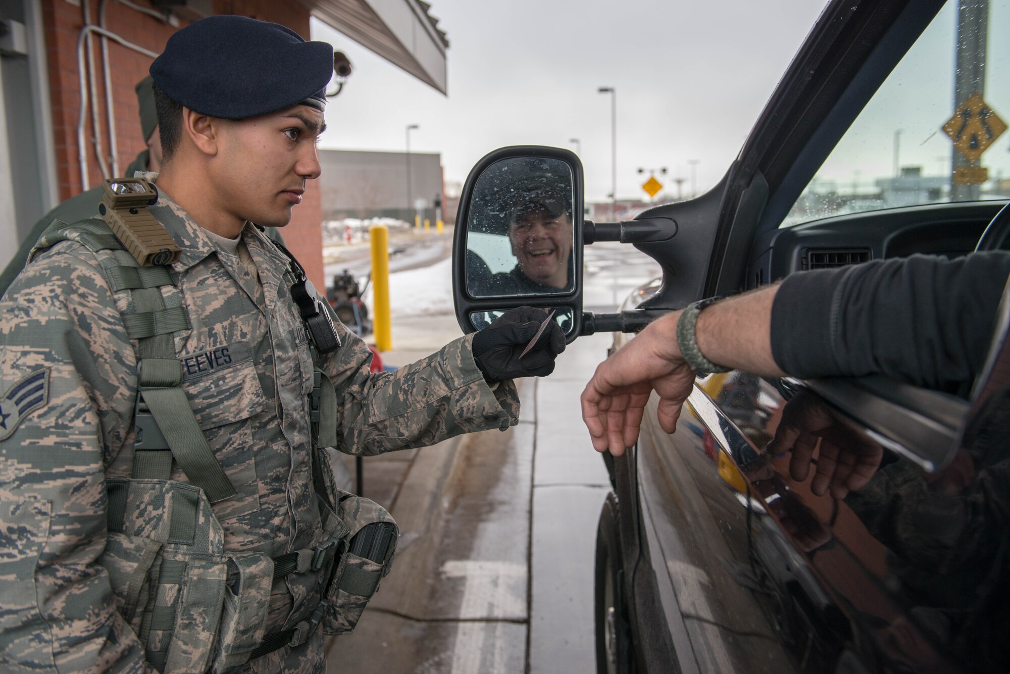 Senior Airman Caleb Steeves checks an I.D. card at the main gate of the Minneapolis-St. Paul Air Reserve Station Jan. 30. (U.S. Air Force Photo by Staff Sgt. Trevor Saylor)