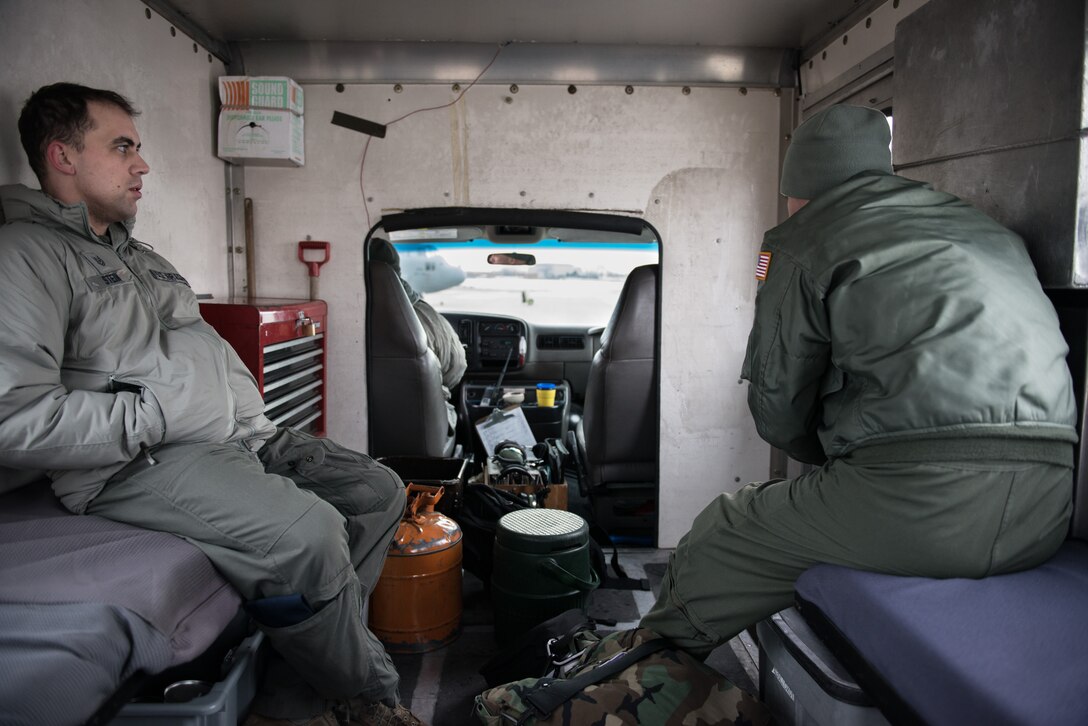 Master Sgt. Jim N. Erickson, 934th Aircraft Maintenance Squadron, drives Tech. Sgt. David F. Stein, 96th Airlift Squadron, out to a C-130 at the Minneapolis-St. Paul Air Reserve Station, Minn. The maintenance squadrons must work through cold weather conditions during the winter season. (U.S. Air Force photo by Staff Sgt. Corban D. Lundborg/Released) 