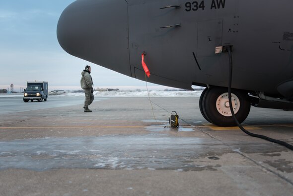 Staff Sgt. Seth D. Johnson, 934th Aircraft Maintenance Squadron, preforms routine pre-flight maintenance checks on a C-130 at the Minneapolis-St. Paul Air Reserve Station, Minn. The maintenance squadrons must work through cold weather conditions that are present during the winter season. (U.S. Air Force photo by Staff Sgt. Corban D. Lundborg/Released) 