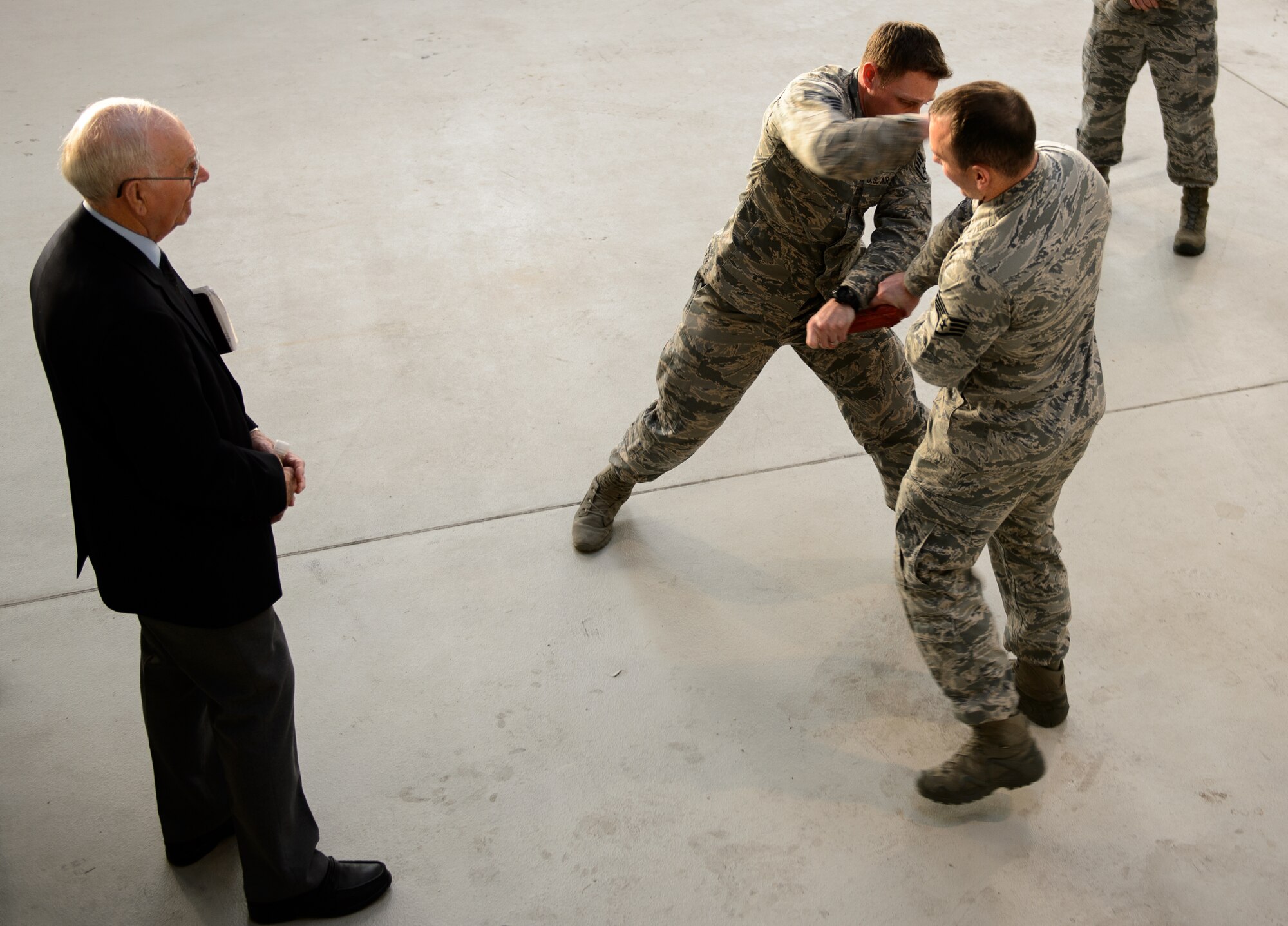 Sam E. Parish, retired Chief Master Sergeant of the Air Force, watches as two Airmen from the 435th Security Forces Squadron demonstrate skills taught to their students Jan. 26, 2016 at Ramstein Air Base, Germany. Many of the 435th Air Ground Operations Wing units showcased their missions to Parish during his visit to Ramstein. During his visit Parish also learned about the three wings at Ramstein and was the guest speaker at the chief master sergeant’s induction ceremony. (U.S. Air Force photo/Staff Sgt. Armando A. Schwier-Morales)