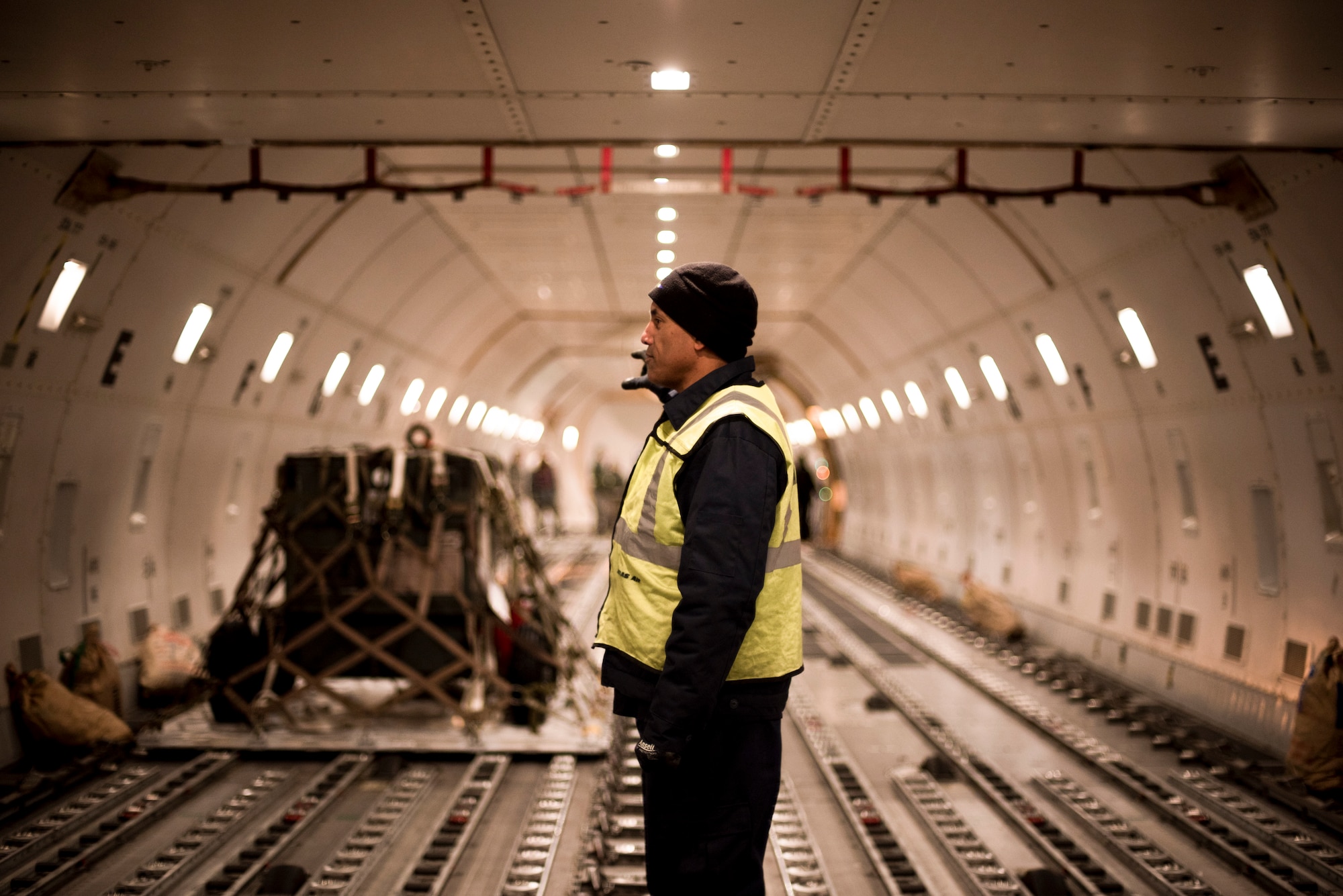 A load crew member guides a pallet Feb. 1, 2016, at Misawa Air Base, Japan. Roughly 200,000 pounds worth of cargo was transported to Andersen Air Force Base, Guam, in preparation of Cope North, a multinational deployment that employs numerous Airmen across the base to help improve combat readiness, develop a synergistic disaster response and increase interoperability between partner nations. (U.S. Air Force photo by Senior Airman Brittany A. Chase)