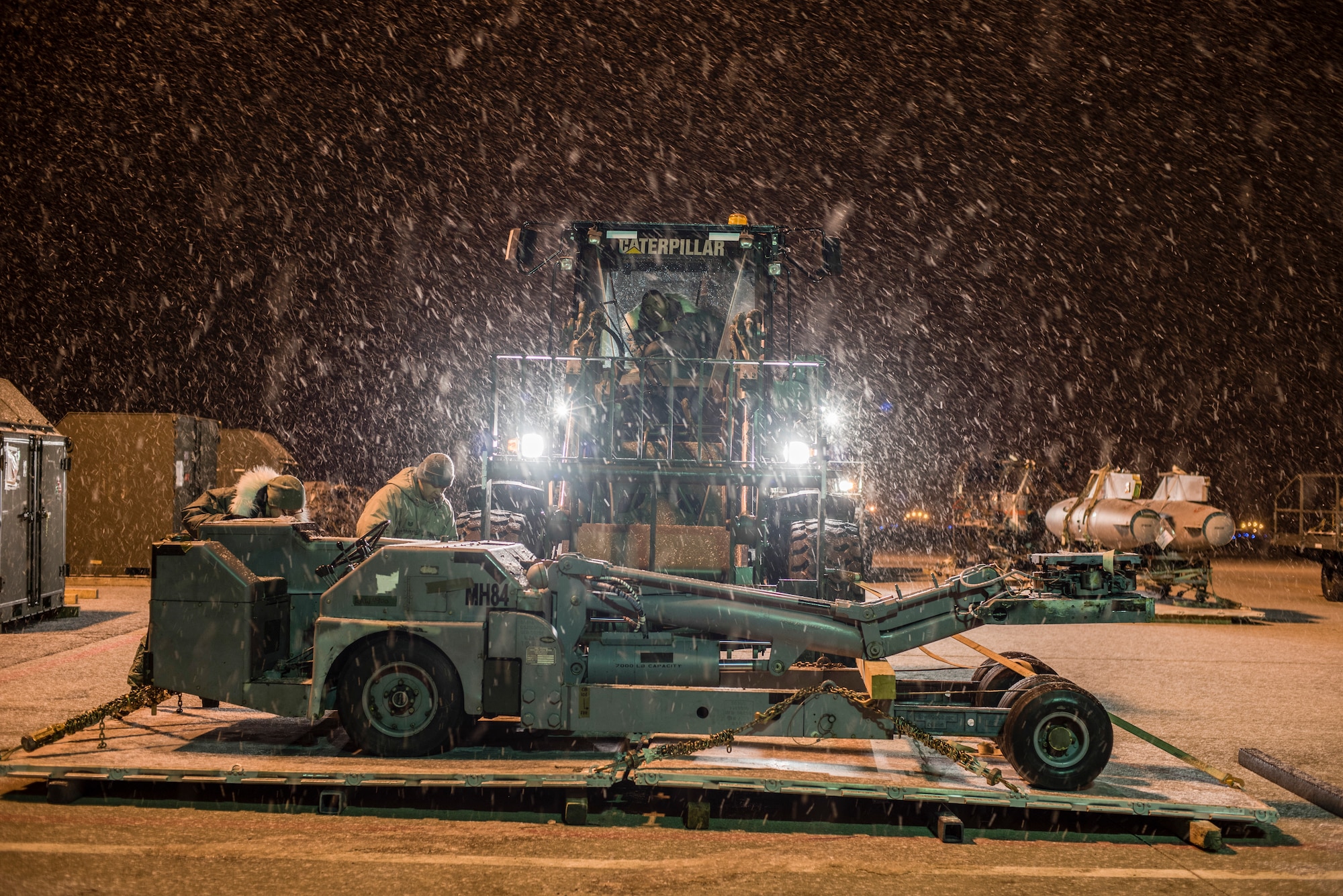 U.S. Air Force Airmen straps down a lift truck Feb. 1, 2016, at Misawa Air Base, Japan. Airmen built the pallets two days prior in preparation of Cope North. The annual exercise serves as a keystone event to promote stability and security throughout the Indo-Asia-Pacific region by enabling regional forces to hone vital readiness skills critical to maintaining regional stability. (U.S. Air Force photo by Senior Airman Brittany A. Chase) 