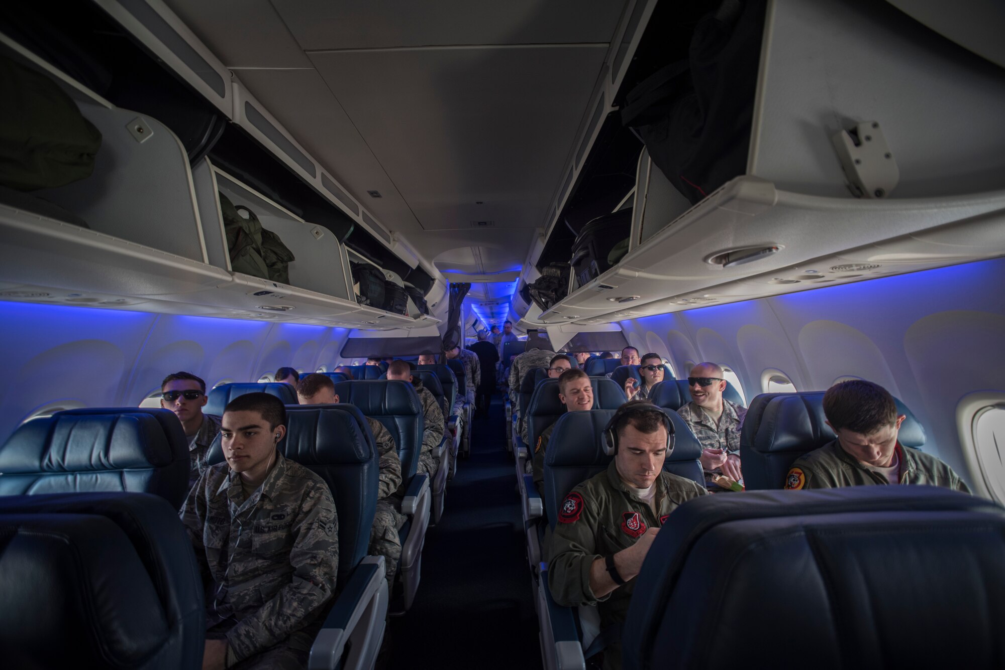 U.S. Air Force Airmen sit in an aircraft Jan. 30, 2016, at Misawa Air Base, Japan. Airmen are travelling to Andersen Air Force Base, Guam, to participate in Cope North; this is a multinational deployment that employs numerous Airmen across the base to help improve combat readiness, develop a synergistic disaster response and increase interoperability between partner nations. (U.S. Air Force photo by Senior Airman Brittany A. Chase)