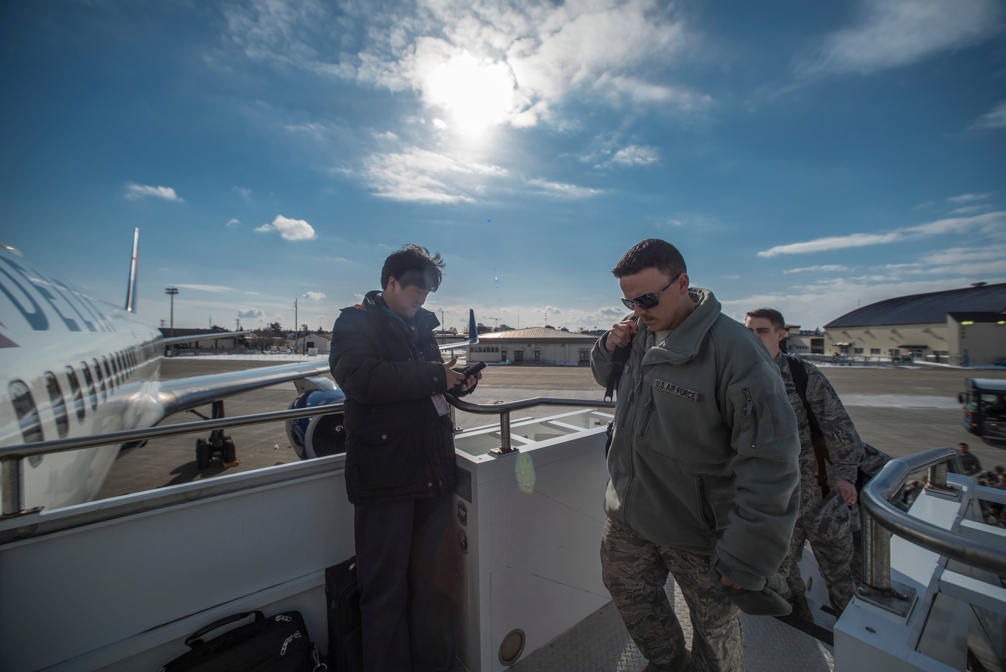 U.S. Air Force Airmen board an aircraft Jan. 30, 2016, at Misawa Air Base, Japan. Airmen departed to Andersen Air Force Base, Guam, as part of Cope North exercise. The annual exercise serves as a keystone event to promote stability and security throughout the Indo-Asia-Pacific region by enabling regional forces to hone vital readiness skills critical to maintaining regional stability. (U.S. Air Force photo by Senior Airman Brittany A. Chase)