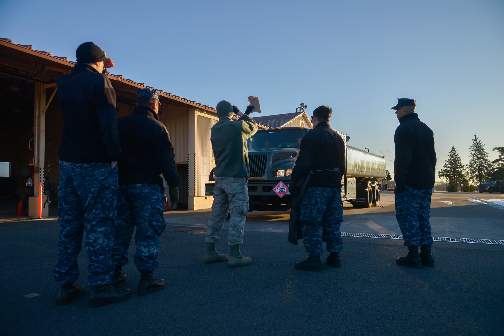 Senior Airman Tyler Sims, 374th Logistics Readiness Squadron fuels management flight fuels training supervisor, shows Sailors from Naval Air Facility Atsugi how to properly stop R-11 refueling trucks at Yokota Air Base, Japan, Jan. 26, 2016. The Navy personnel who received training on the R-11 refueling trucks learned how to drive, service aircraft, perform minor maintenance and how to check fuel samples with the vehicles. (U.S. Air Force photo by Senior Airman David Owsianka/Released)