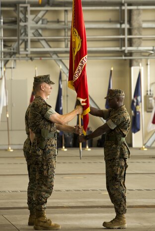 U.S. Marine Corps Sgt. Maj. Darnell T. Richardson, right, Headquarters and Headquarters Squadron sergeant major, passes the squadron guidon to Lt. Col. Karl T. Schmidt, outgoing H&HS commanding officer, during a change of command ceremony at Marine Corps Air Station Iwakuni, Japan, June 30, 2016. The passing of the guidon symbolizes the end of Schmidt’s role as commanding officer after serving in the position since June 9, 2014. (U.S. Marine Corps photo by Lance Cpl. Jacob Farbo/Released)