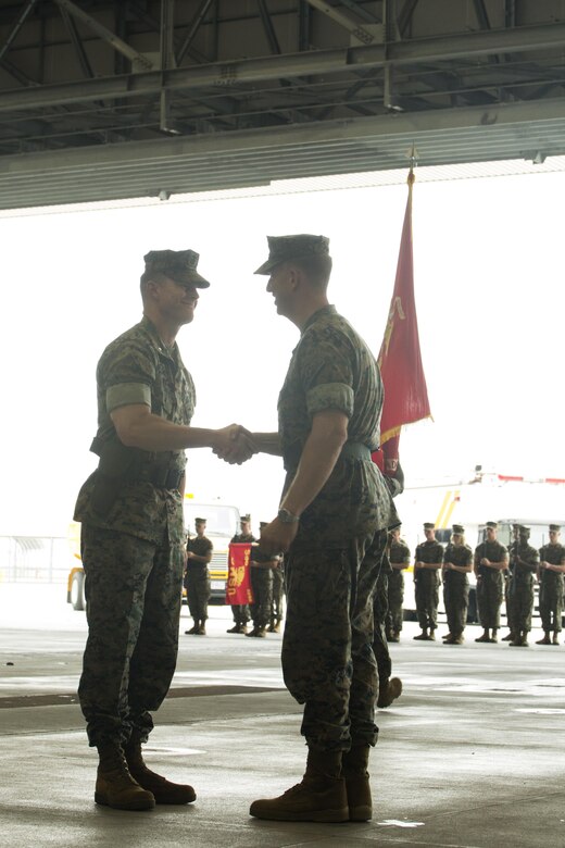U.S. Marine Corps Lt. Col. Karl T. Schmidt, right, outgoing Headquarters and Headquarters Squadron commanding officer, and Lt. Col. Kevin A. Campbell, incoming H&HS commanding officer, shake hands during a change of command ceremony at Marine Corps Air Station, Iwakuni, Japan, June 30, 2016. Schmidt served honorably and faithfully as the commanding officer for H&HS since June 9, 2016, and will remain at MCAS Iwakuni as the air operations officer for approximately 10 months. (U.S. Marine Corps photo by Lance Cpl. Donato Maffin/Released)
