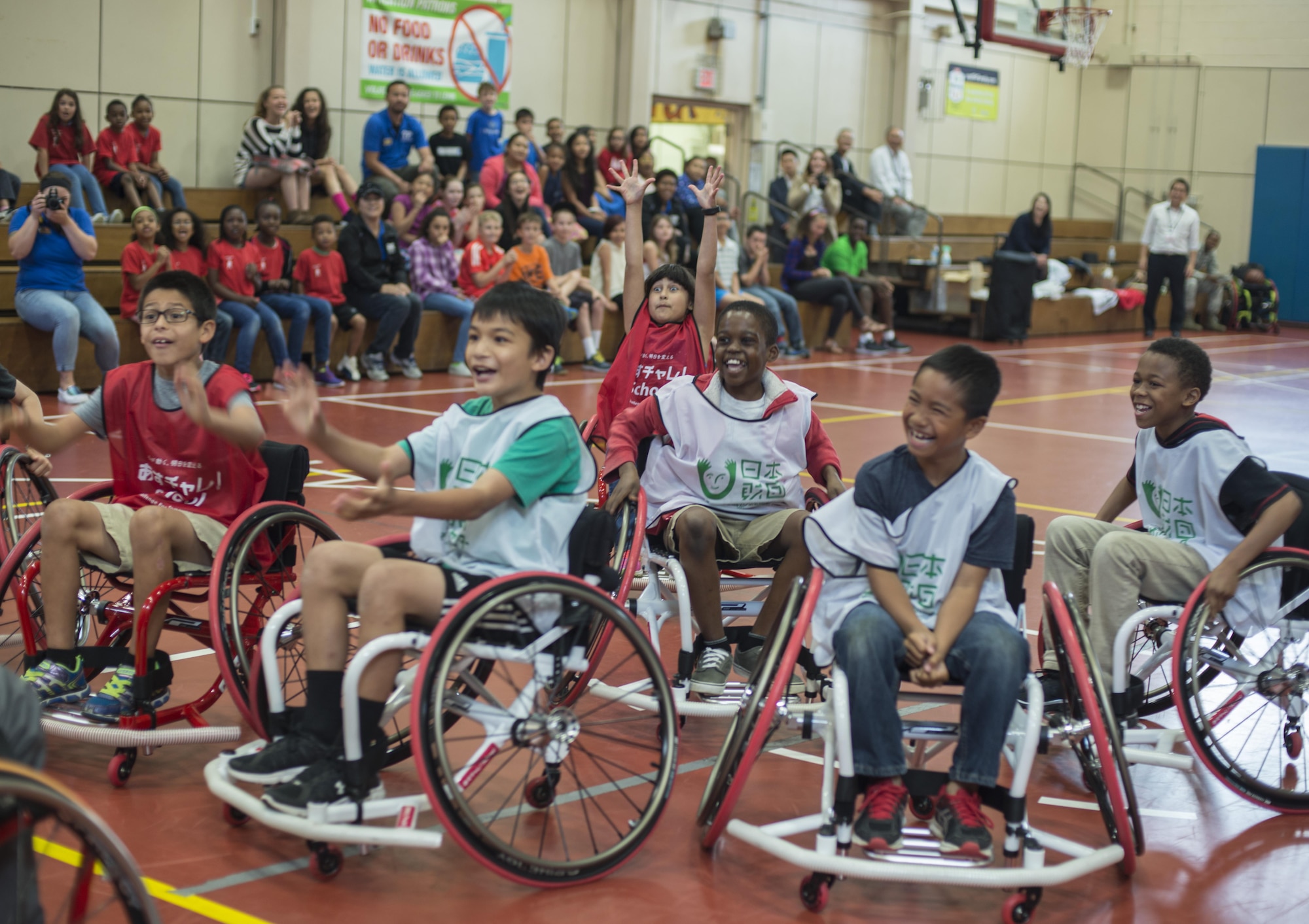 Children at the Lunney Youth Center play basketball in wheelchairs at Misawa Air Base, Japan, June 28, 2016. The children were able to experience the difficulties of being in a wheelchair firsthand, while being coached by Shinji Negi, the captain of the Japan Men's National Wheelchair Basketball Team at the 2000 Sydney Paralympic Games. (U.S. Air Force photo by Senior Airman Brittany A. Chase)