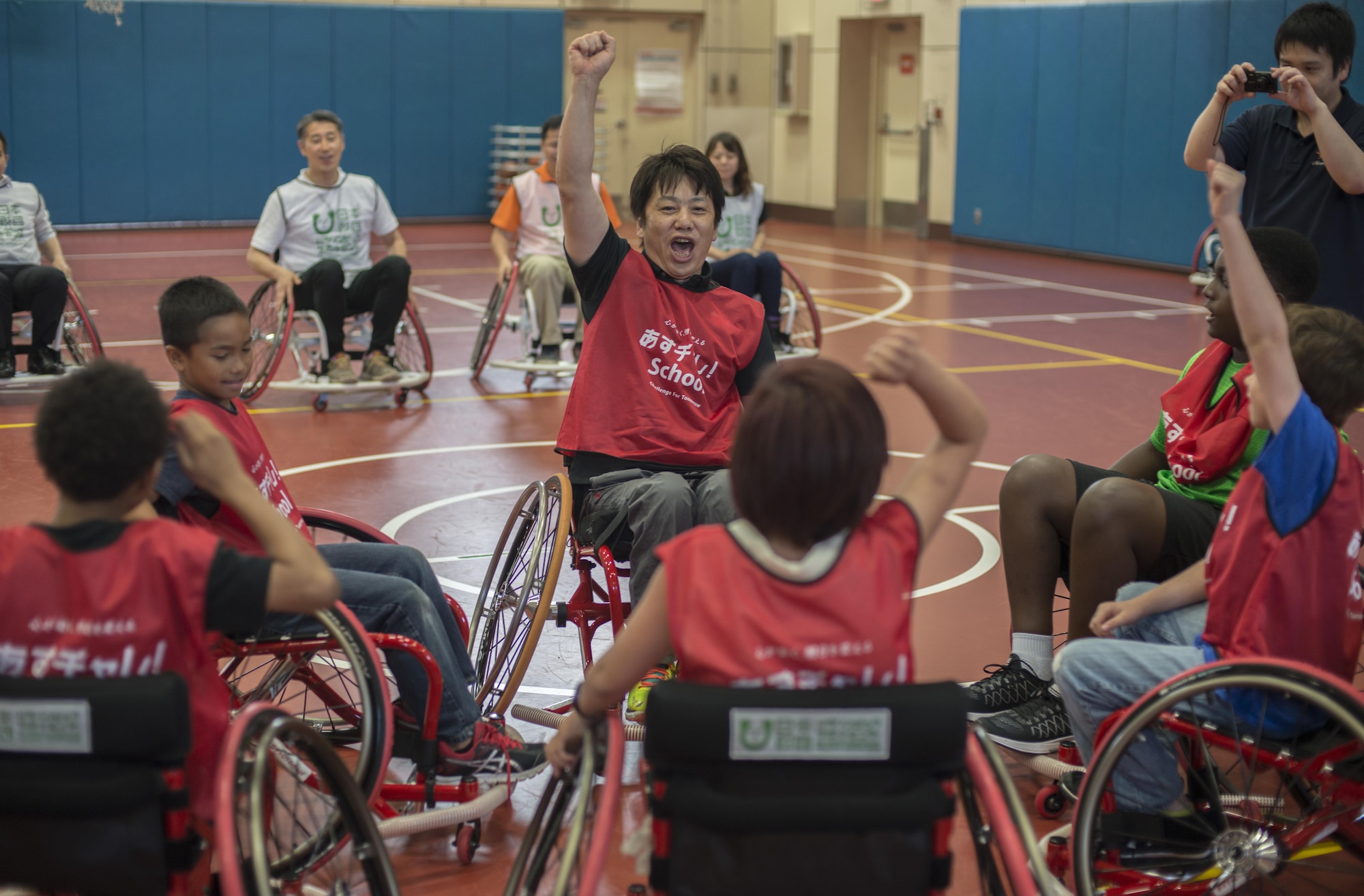 Shinji Negi, a project director with the Nippon Foundation Paralympic Support Center, chants with children at the Lunney Youth Center at Misawa Air Base, Japan, June 28, 2016. Negi travels across the world in order to teach children about life with disabilities and persevering despite difficulties that may occur in life. He was paralyzed from the waist down in high school and went on to become the captain of the Japan Men's National Wheelchair Basketball Team at the 2000 Sydney Paralympic Games. (U.S. Air Force photo by Senior Airman Brittany A. Chase)