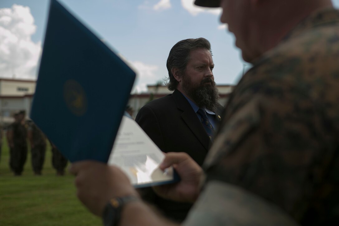 Retired Master Sgt. Robert Alexander Jr. receives his fourth Navy and Marine Corps Commendation Medal, June 23, 2016, at Camp Schwab, Okinawa, Japan. He is receiving it for his life-saving actions in Subic Bay, Philippines, after a night-time amphibious training exercise in 1988. He is a Fitchburg, Massachusetts, native living in Okinawa, Japan. (U.S. Marine Corps photo by Cpl. Tyler Ngiraswei/ Released)