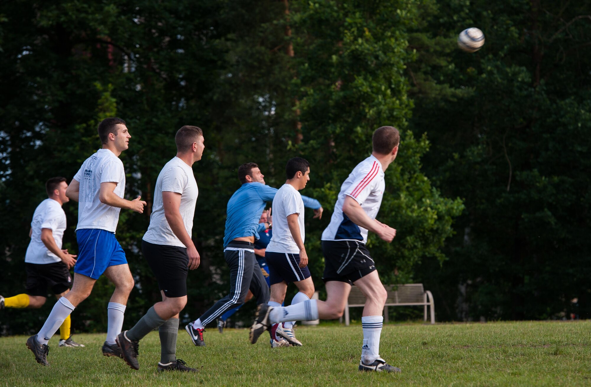 Soccer players run down the field after their team’s goalkeeper throws the ball during an intramural soccer season finals game June 29, 2016, at Ramstein Air Base, Germany. Intramural sports are one of many ways Airmen can stay fit and competitive throughout the year, and allows participants to enhance camaraderie and communicative abilities. (U.S. Air Force photo/Airman 1st Class Lane T. Plummer)