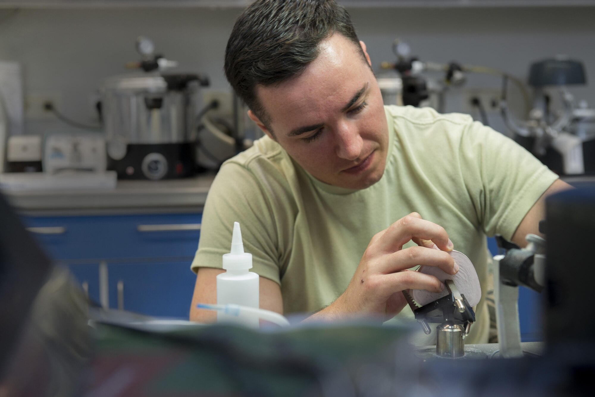 Senior Airman Dylan Lemos, 86th Dental Squadron dental lab technician, bends a wire around a mold of teeth to create a retainer June 30, 2016, at Ramstein Air Base, Germany. The dental lab is divided into two sections, the base dental lab and the area dental lab. The base dental lab provides for Ramstein, while the area dental lab provides for several bases throughout U.S. Air Forces in Europe. (U.S. Air Force photo/Airman 1st Class Tryphena Mayhugh)