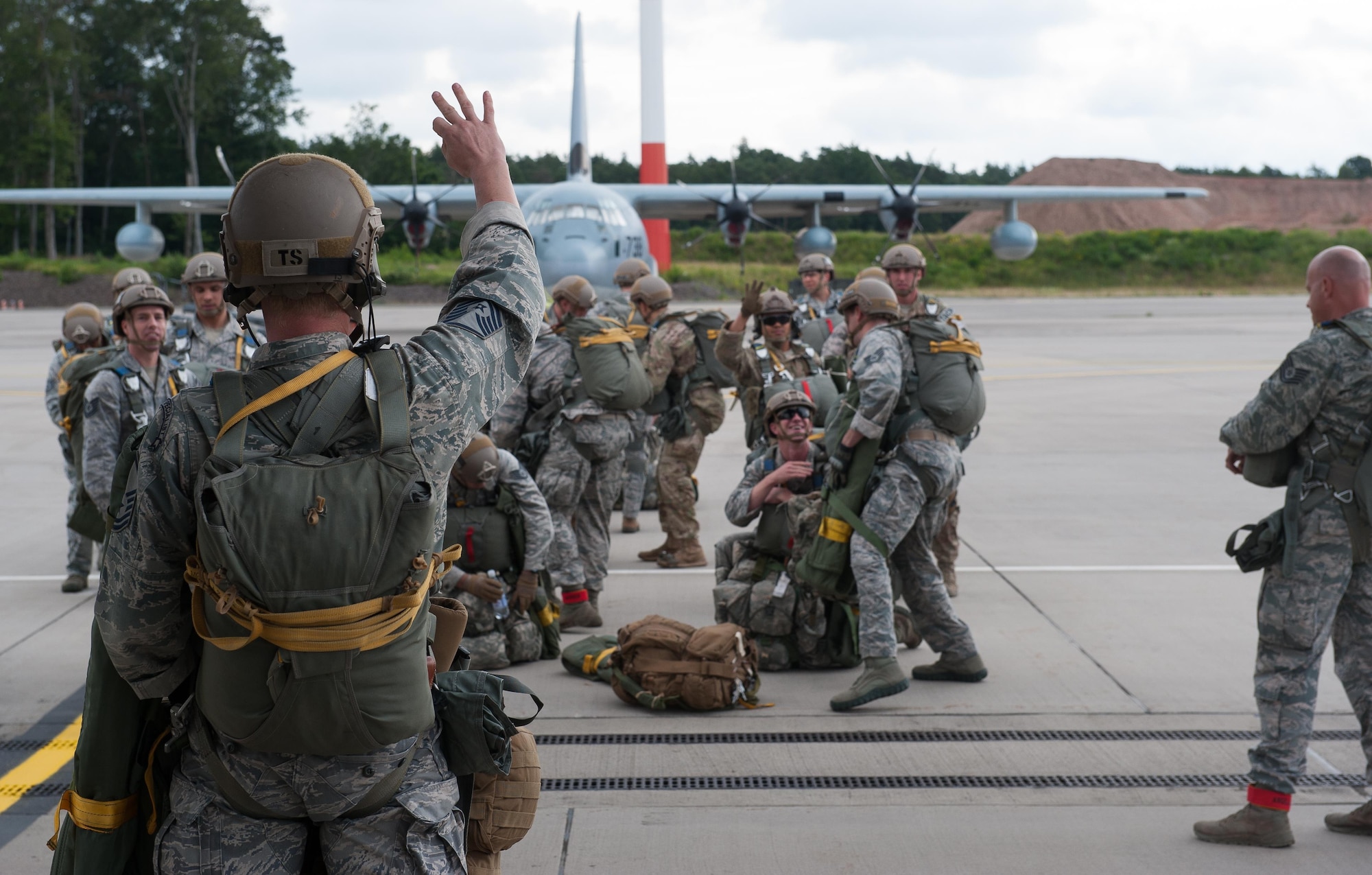 Airmen from the 2nd Air Support Operations Squadron prepare to board a C-130J Super Hercules during a Joint Airborne Air Transportability Training exercise June 30, 2016, at Ramstein Air Base, Germany. The exercise involved the 37th Airlift Squadron flying 2nd ASOS Airmen over a landing zone in France, where they successfully jumped and landed. (U.S. Air force photo/Airman 1st Class Lane T. Plummer)