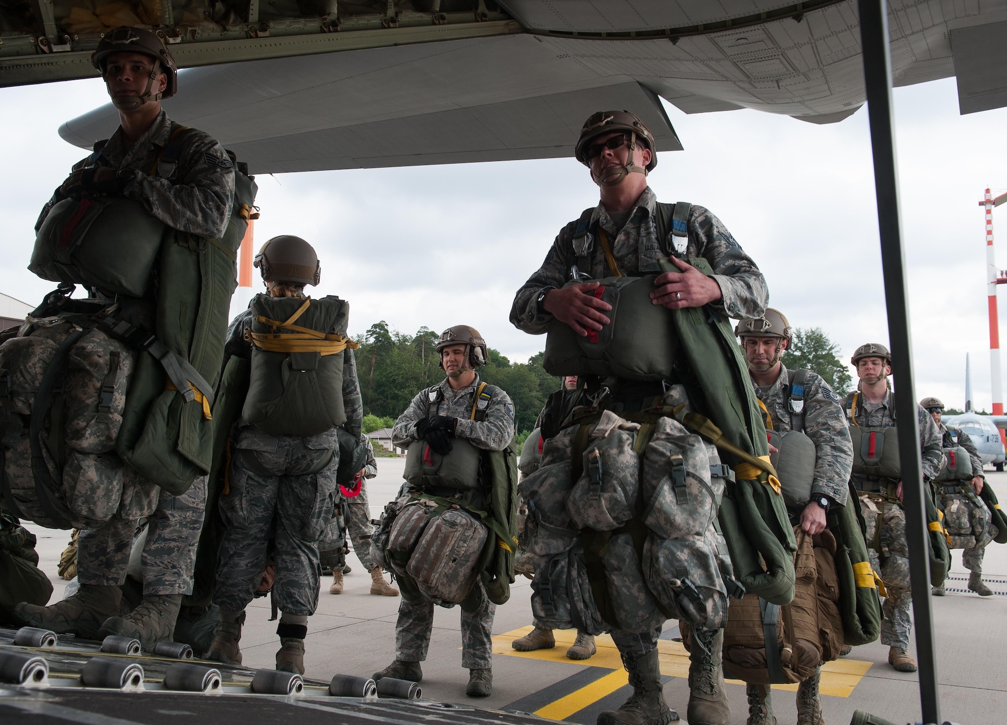Airmen from the 2nd Air Support Operations Squadron board a C-130J Super Hercules to participate in a Joint Airborne Air Transportability Training exercise with the 37th Airlift Squadron June 30, 2016, at Ramstein Air Base, Germany. The exercise allowed the Airmen to test their abilities in flying to a location and successfully jumping out and landing in a designated area, to prepare for future real-world scenarios. (U.S. Air force photo/Airman 1st Class Lane T. Plummer)