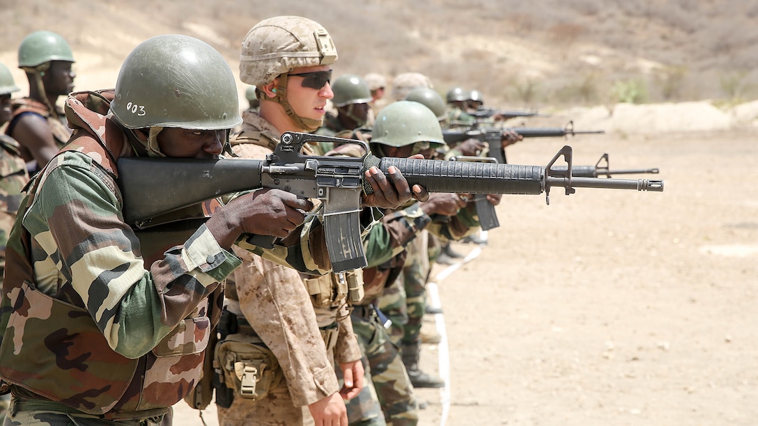 LCpl Thomas Jamieson, a rifleman with Special Purpose Marine Air-Ground Task Force Crisis Response-Africa, observes a live-fire training exercise with the Compagnie Fusilier de Marin Commando in Thies, Senegal, June 22 2016. Marines and the COFUMACO conducted a three-week training exercise that included advanced combat firing techniques, a machine gun range and a live-fire platoon attack range.