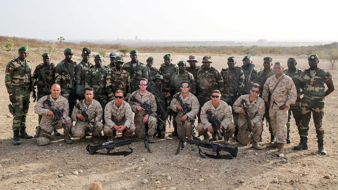 Marines with Special Purpose Marine Air-Ground Task Force Crisis Response-Africa  pose for a picture with the Compagnie Fusilier de Marin Commando in Thies, Senegal, June 22, 2016. Marines and the COFUMACO conducted a three-week training exercise that included advanced combat firing techniques, a machine gun range and a live-fire platoon attack range. 