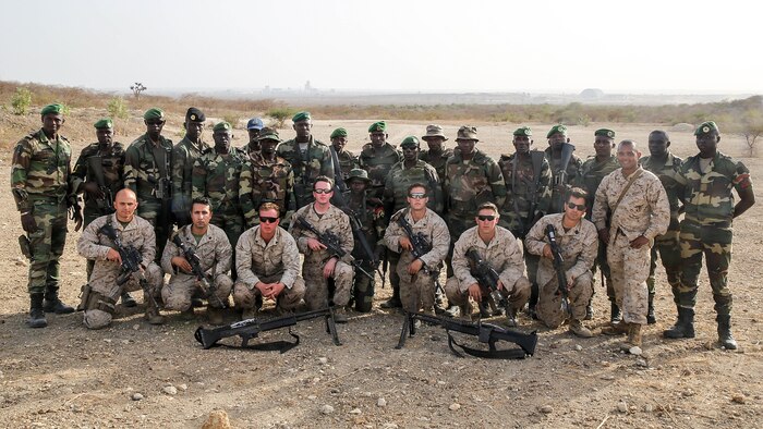Marines with Special Purpose Marine Air-Ground Task Force Crisis Response-Africa  pose for a picture with the Compagnie Fusilier de Marin Commando in Thies, Senegal, June 22, 2016. Marines and the COFUMACO conducted a three-week training exercise that included advanced combat firing techniques, a machine gun range and a live-fire platoon attack range. 