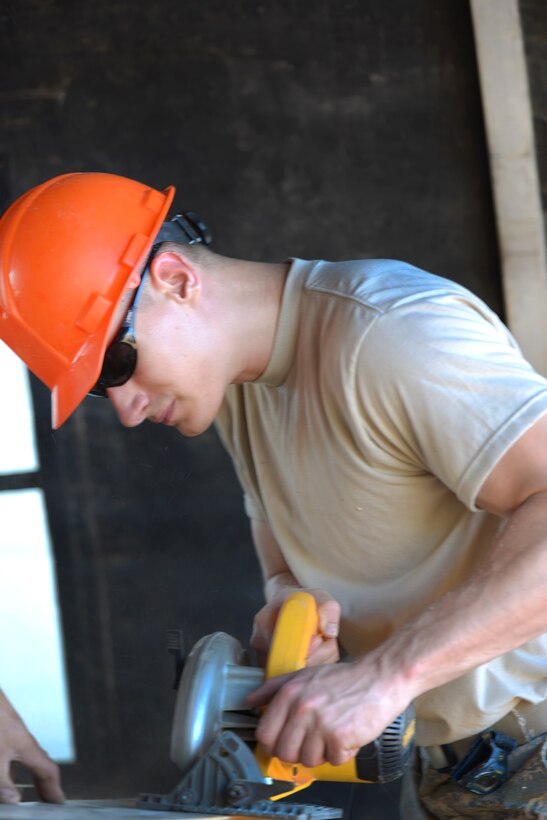 Senior Airman Alan Bauman cuts wood that will be used to repair a cement mold during construction of the Commando Warrior Field Training Facility at Andersen Air Force Base, Guam, June 22, 2016. Bauman is assigned to the New Hampshire Air National Guard’s 157th Civil Engineering Squadron. Air National Guard photo by Tech. Sgt. Aaron Vezeau