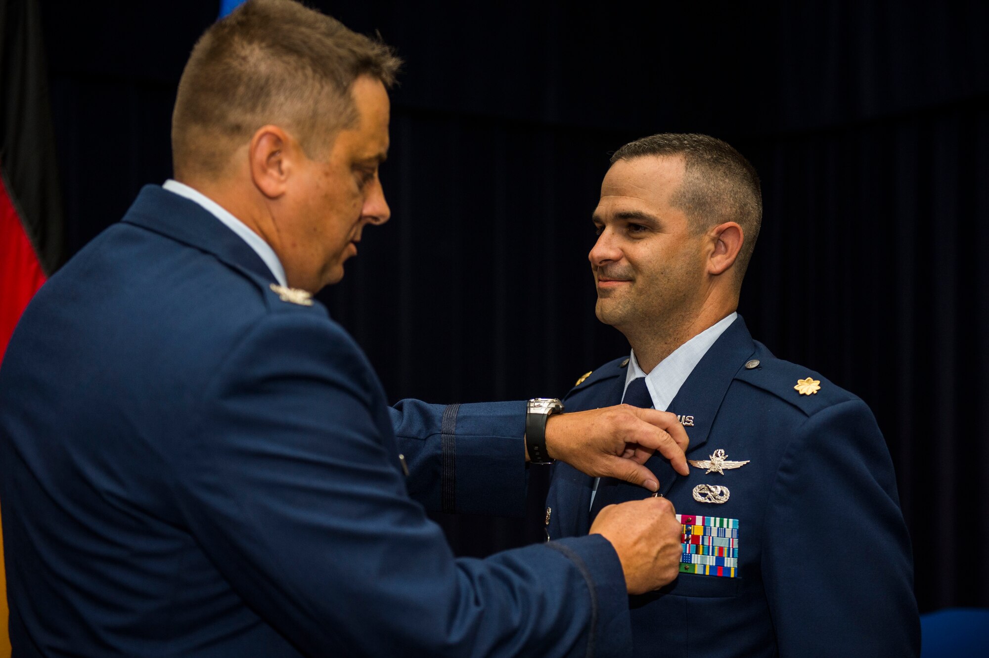 U.S. Air Force Col. Steven Zubowicz, 52nd Mission Support Group commander, left, pins a Meritorious Service Medal onto U.S. Air Force Maj. Duane Fisher, former 52nd Communications Squadron commander, during the 52nd CS change of command ceremony in the Club Eifel Ballroom at Spangdahlem Air Base, Germany, July 1, 2016. The Meritorious Service Medal is awarded to members of the Armed Forces of the United States and friendly foreign nations who distinguished themselves by outstanding noncombat meritorious achievement. (U.S. Air Force photo by Senior Airman Luke Kitterman/Released)