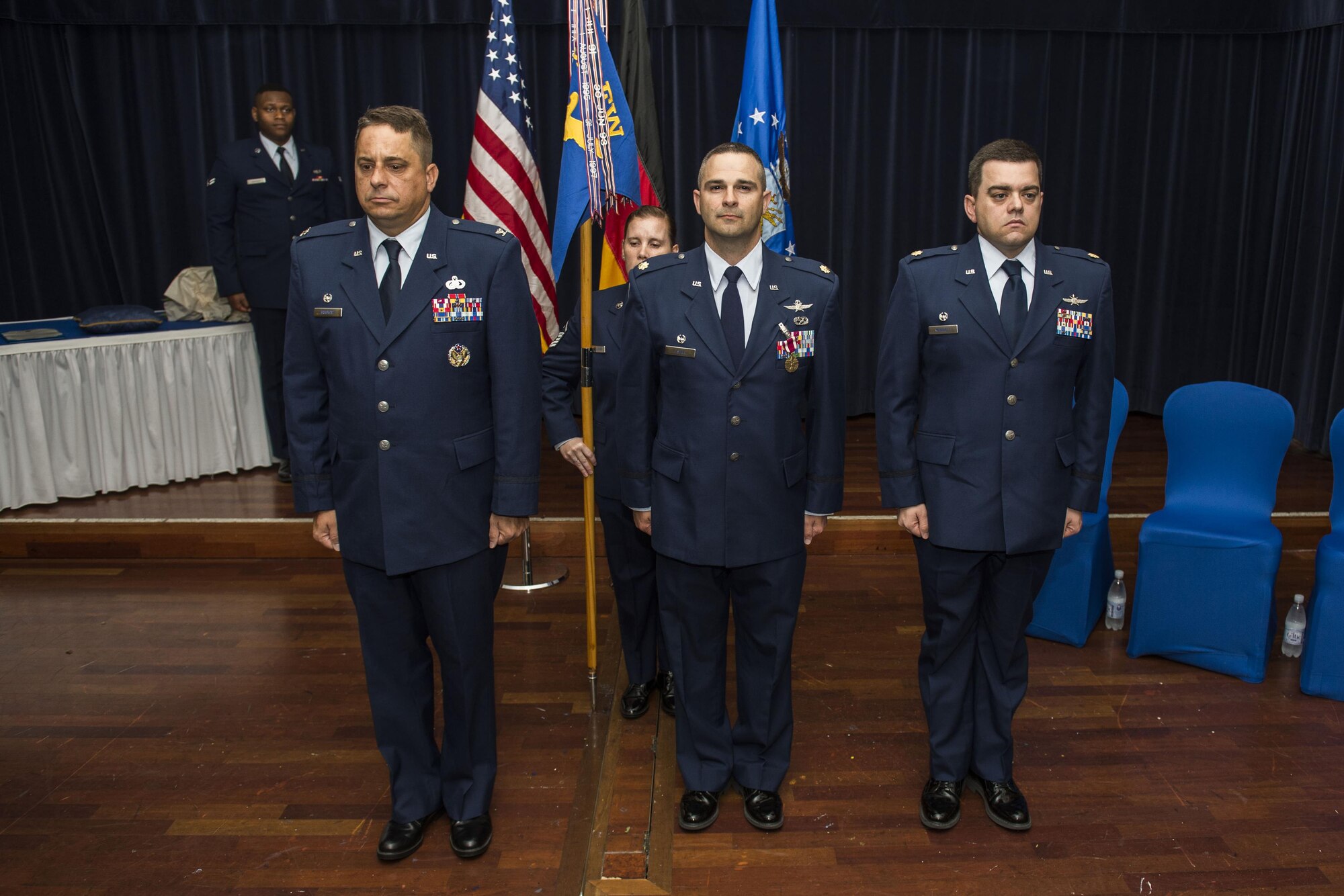 U.S. Air Force Col. Steven Zubowicz, 52nd Mission Support Group commander, left, U.S. Air Force Maj. Duane Fisher, former 52nd Communications Squadron commander, center, and U.S. Air Force Maj. Christopher Waddell, 52nd CS commander, right, stand at attention during the 52nd CS change of command ceremony in the Club Eifel Ballroom at Spangdahlem Air Base, Germany, July 1, 2016. Zubowicz was the presiding officer for ceremony and exchanged command of the 52nd CS from Fisher to Waddell. (U.S. Air Force photo by Senior Airman Luke Kitterman/Released)