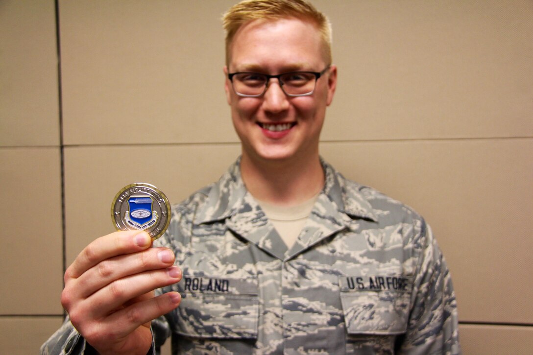Senior Airman Kyle Roland, 932nd Force Support Squadron, was awarded a special honor recently with a beautiful full color 932nd Airlift Wing commander's coin by Col. Jonathan Philebaum for his outstanding computer administration and organizational skills.  His work behind the scenes helps the wing's vision for creating an innovative, professional unrivaled force postured to meet the global challenges of tomorrow.  (U.S. Air Force photo by Maj. Stan Paregien)