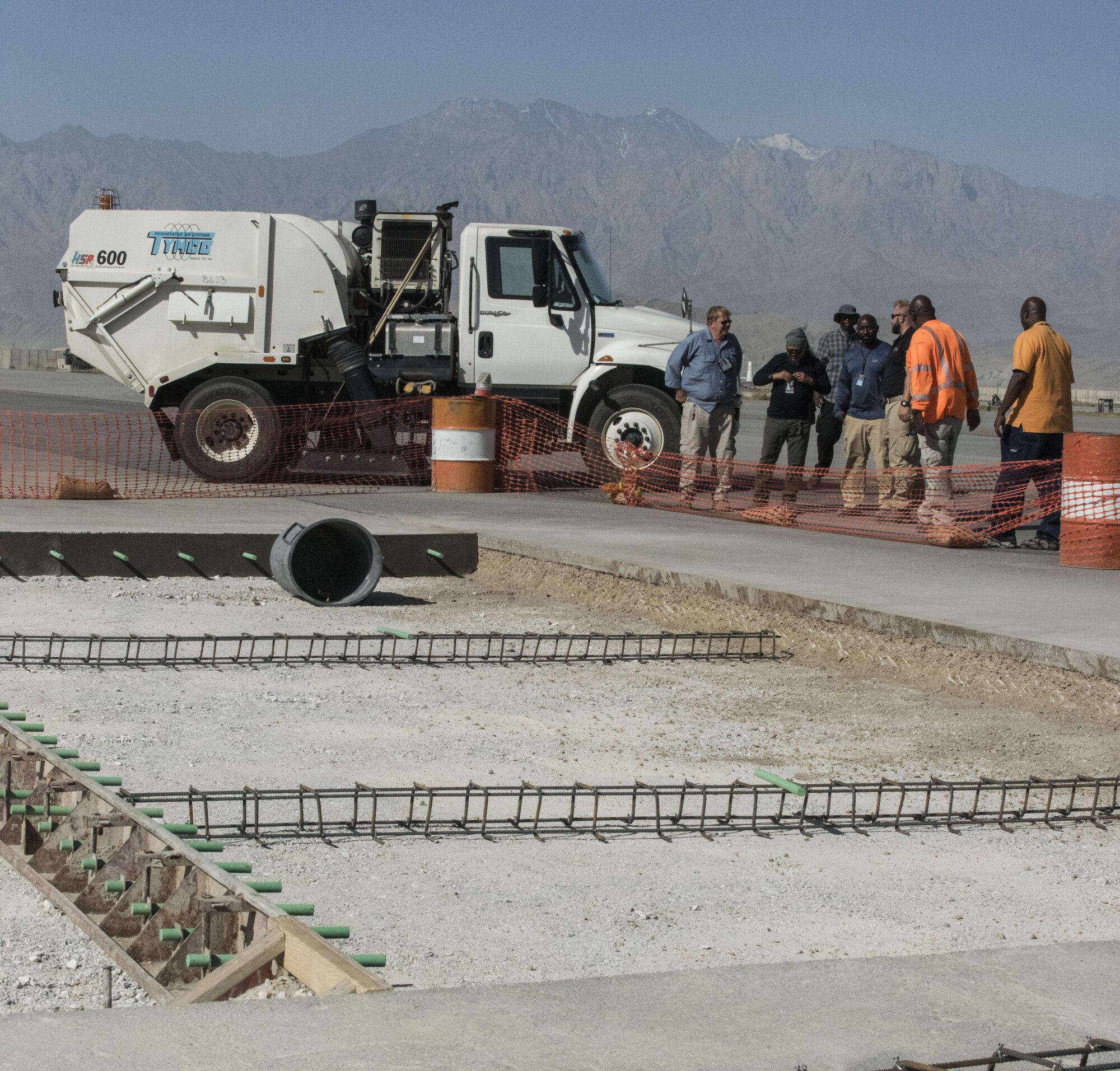 Airfield management works with engineers to ensure all foreign object debris is cleared around a construction site on the airfield, July 1, 2016, Bagram Airfield, Afghanistan. Airfield management is overseeing the removal of piles of rocks that will be replaced by concrete to create a safer landing surface for aircraft. (U.S. Air Force photo by Tech. Sgt. Tyrona Lawson)