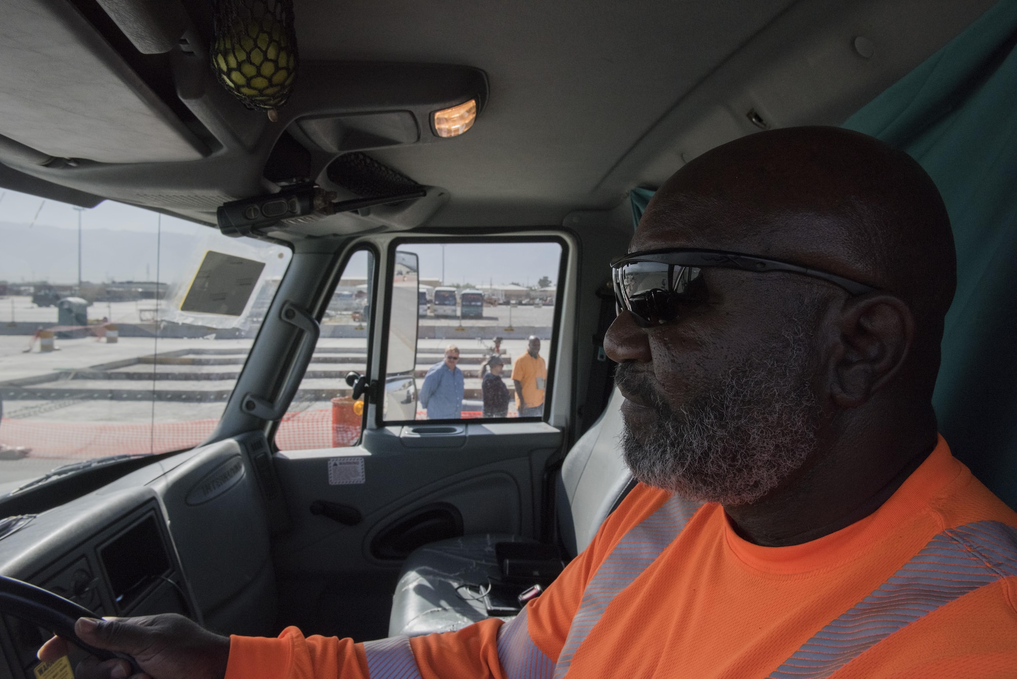 Darrel Gibbs, heavy truck driver, responds to an airfield construction site, July 1, 2016, Bagram Airfield, Afghanistan. Gibbs drives a ground sweeper and helps ensure that all foreign object debris such as rocks are cleared from the airfield while construction is going on. (U.S. Air Force photo by Tech. Sgt. Tyrona Lawson)