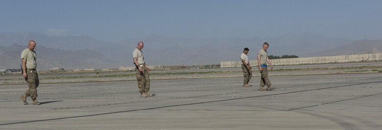 Maintenance Airmen perform a foreign object debris check on the airfield, July 1, 2016, Bagram Airfield, Afghanistan. Airfield management depends on individuals to help keep the airfield FOD free so that aircraft can take off and land safely. (U.S. Air Force photo by Tech. Sgt. Tyrona Lawson)