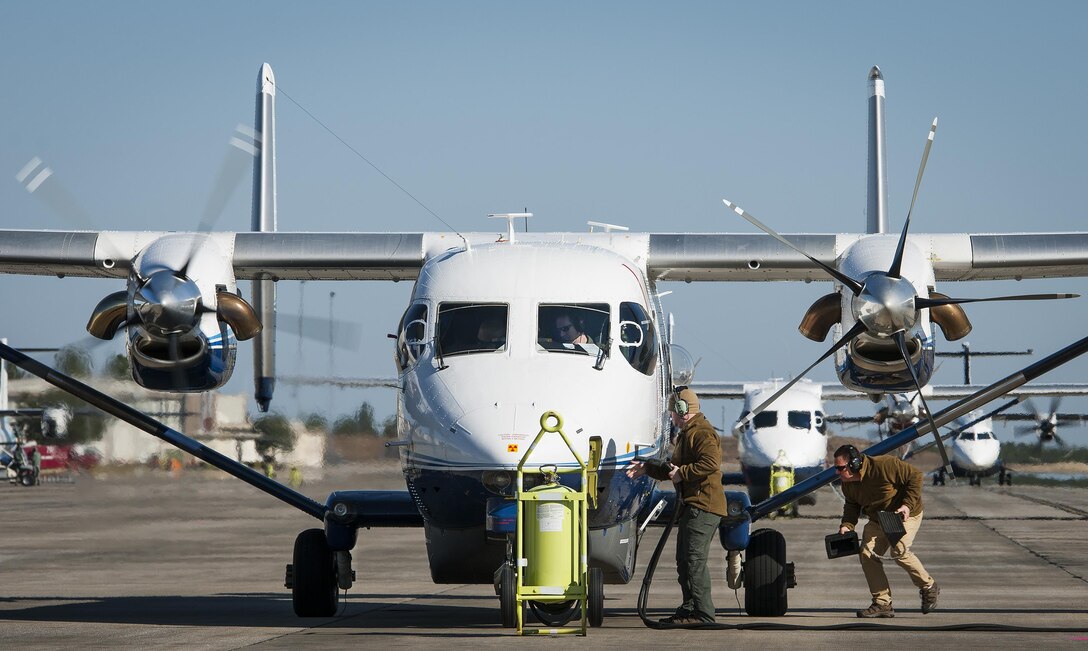 Maintainers with the 919th Special Operations Maintenance Group pull the generator cable and chocks as the aircrew of a C-145A Skytruck prepares for a mission at Duke Field, Fla.  The 919th MXG is responsible for the maintenance of the five Skytrucks in the Air Force fleet.  (U.S. Air Force photo/Tech. Sgt. Sam King)   