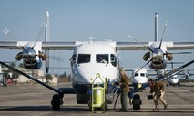 Maintainers with the 919th Special Operations Maintenance Group pull the generator cable and chocks as the aircrew of a C-145A Skytruck prepares for a mission at Duke Field, Fla.  The 919th MXG is responsible for the maintenance of the five Skytrucks in the Air Force fleet.  (U.S. Air Force photo/Tech. Sgt. Sam King)   