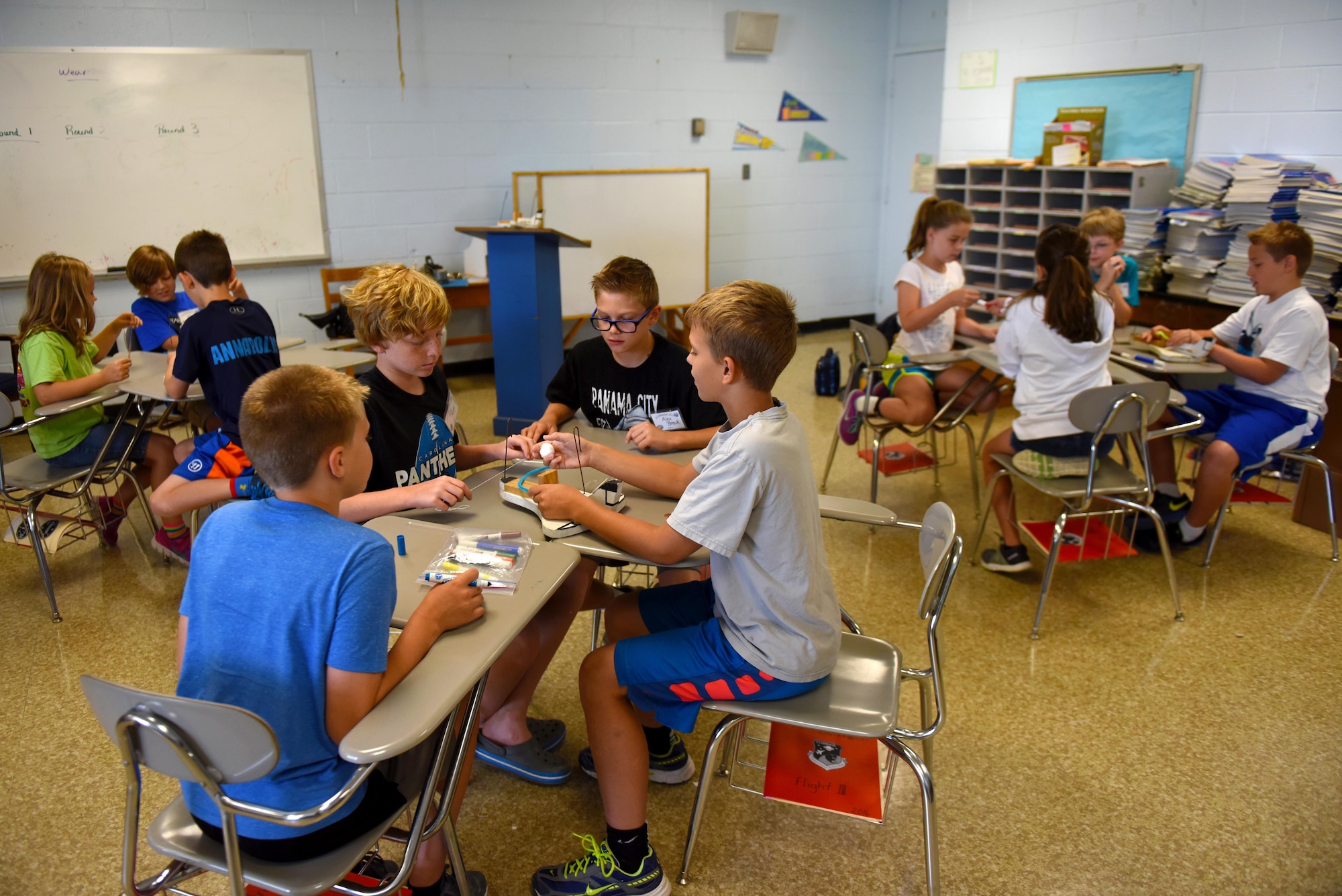 Science and Technology Academies Reinforcing Basic Aviation and Space Exploration students discuss securing an egg to a wooden jet, so the egg doesn’t break, June 22, 2016, at Greenwood Middle School, Goldsboro, North Carolina. The goal of this exercise was to teach the children about force and what it takes to keep a pilot safe. (U.S. Air Force photo/Airman 1st Class Ashley Williamson/Released)
