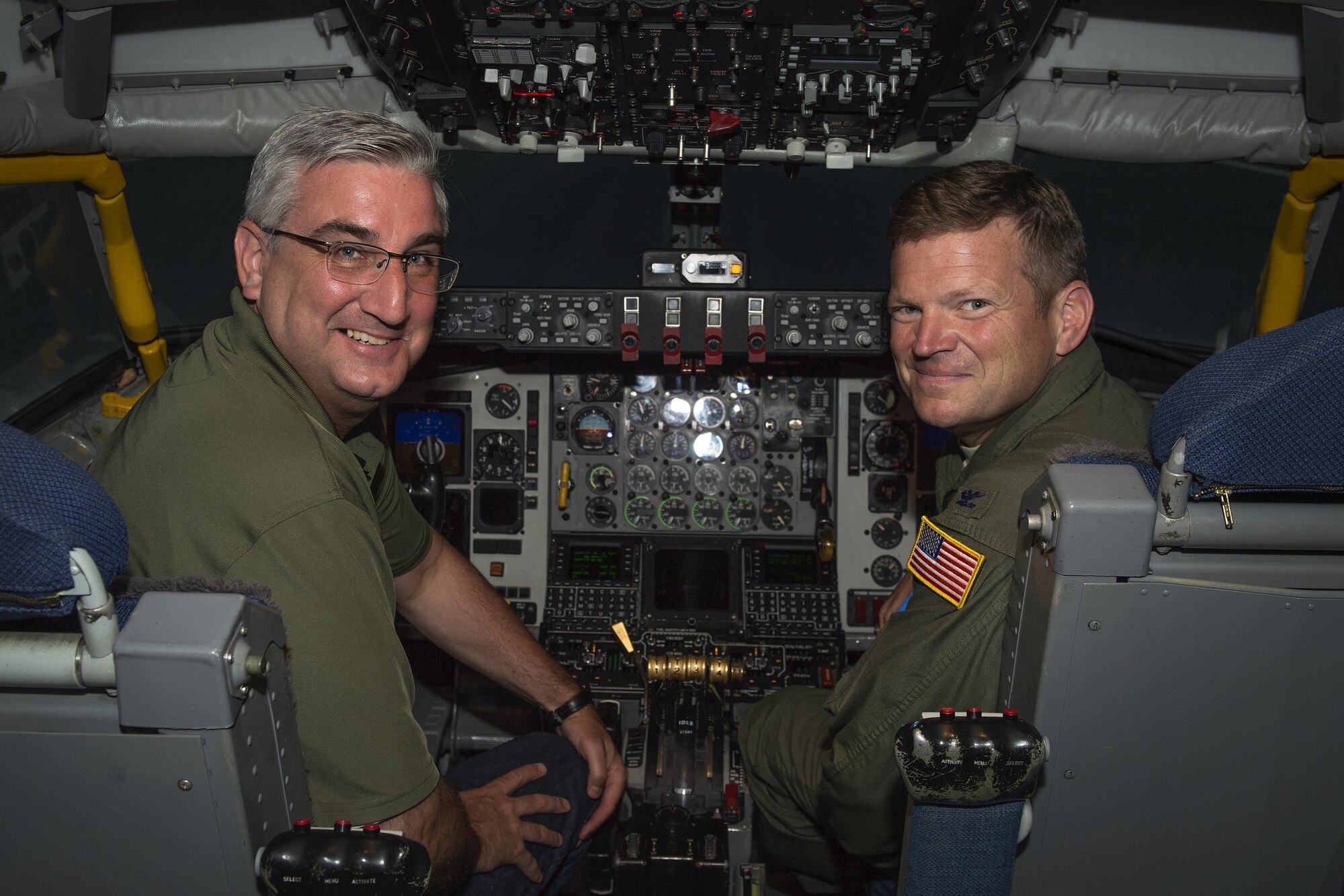Indiana Lt. Gov. Eric Holcomb and Col. Paul Gates, 434th Air Refueling Wing vice commander, pose for a photo in a KC-135R Stratotanker simulator during a visit to Grissom Air Reserve Base, Ind., June 28, 2016. Holcomb and his staff visited Grissom to learn more about the base and its role in both national defense and the Indiana economy. (U.S. Air Force photo/Tech. Sgt. Benjamin Mota)