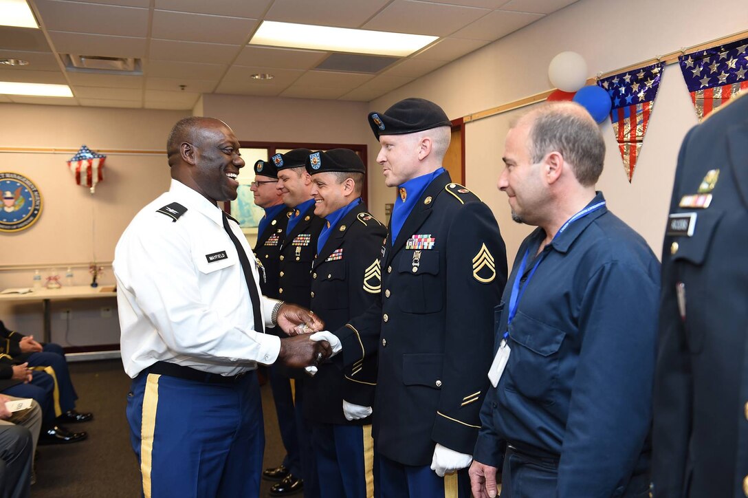 Col. D.D. Mayfield, left, hands out his Defense Contract Management Agency-Chicago command coin to members of the 85th Support Command's color guard team during a change of command ceremony on June 23, 2016.
The color guards team supported various organization functions for DCMA during Mayfield's command.
(Photo by Mr. Anthony L. Taylor)