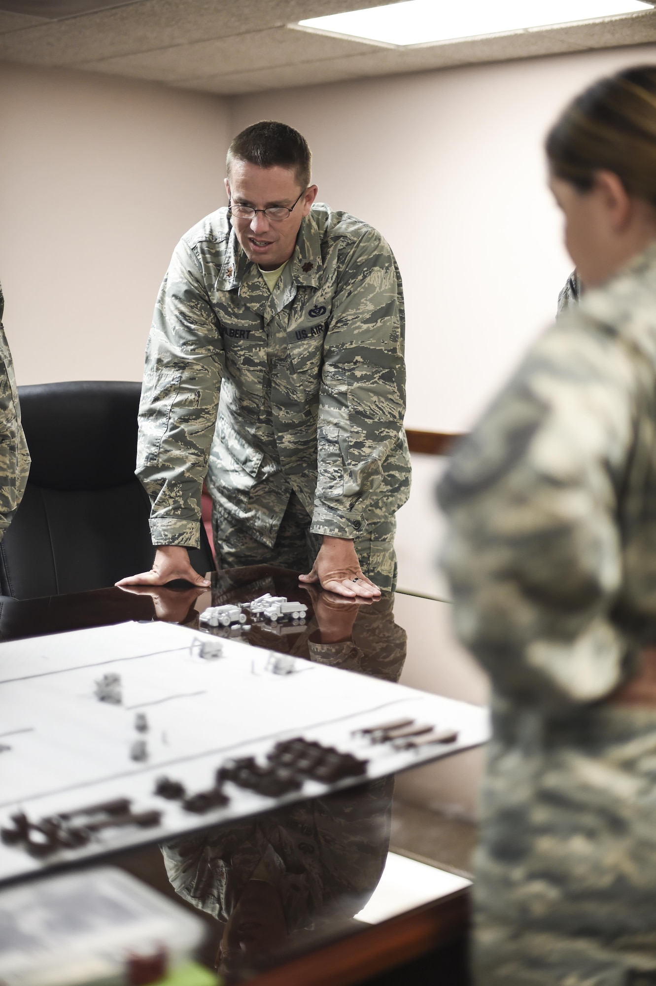 Maj. Myles 49th Civil Engineer Squadron, command executive officer participates in the Rapid Airfield Damage Repair Modernization table top exercise at Holloman Holloman Air Force Base N.M.  on June 27. Member from the RADRM team visited the 49th CES to implement the second phase of a four phase training program for runway repair during and after an enemy attack. Once installations receive the new equipment, the third and fourth phases will begin. Civil engineers will receive hands-on training with the new equipment and begin practicing with actual craters. . (Last names withheld due to operational requirements. U.S. Air Force Photo by Staff Sgt. Stacy Moless)