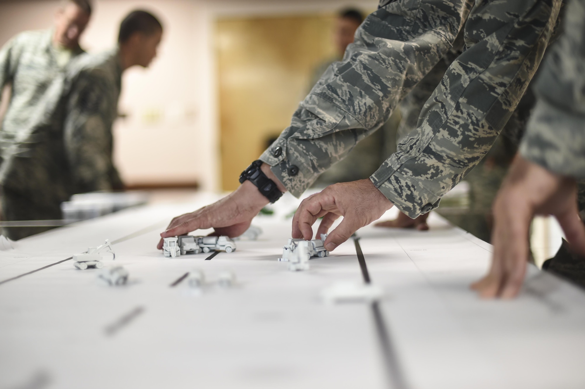 Members of the 49th Civil Engineer Squadron move pieces on a simulated run way during the Rapid Airfield Damage Repair Modernization table top exercise at Holloman Holloman Air Force Base N.M.  on June 27. Member from the RADR team visited the 49th CES to implement the second phase of a four phase training program for runway repair during and after an enemy attack. Mobile training teams will make their way to every Air Force Active Duty, Guard and Reserve installation to teach civil engineers RADR techniques. Over the next few years, this training will be implemented at all Civil Engineering Silver Flag training sites. (U.S. Air Force Photo by Staff Sgt. Stacy Moless)