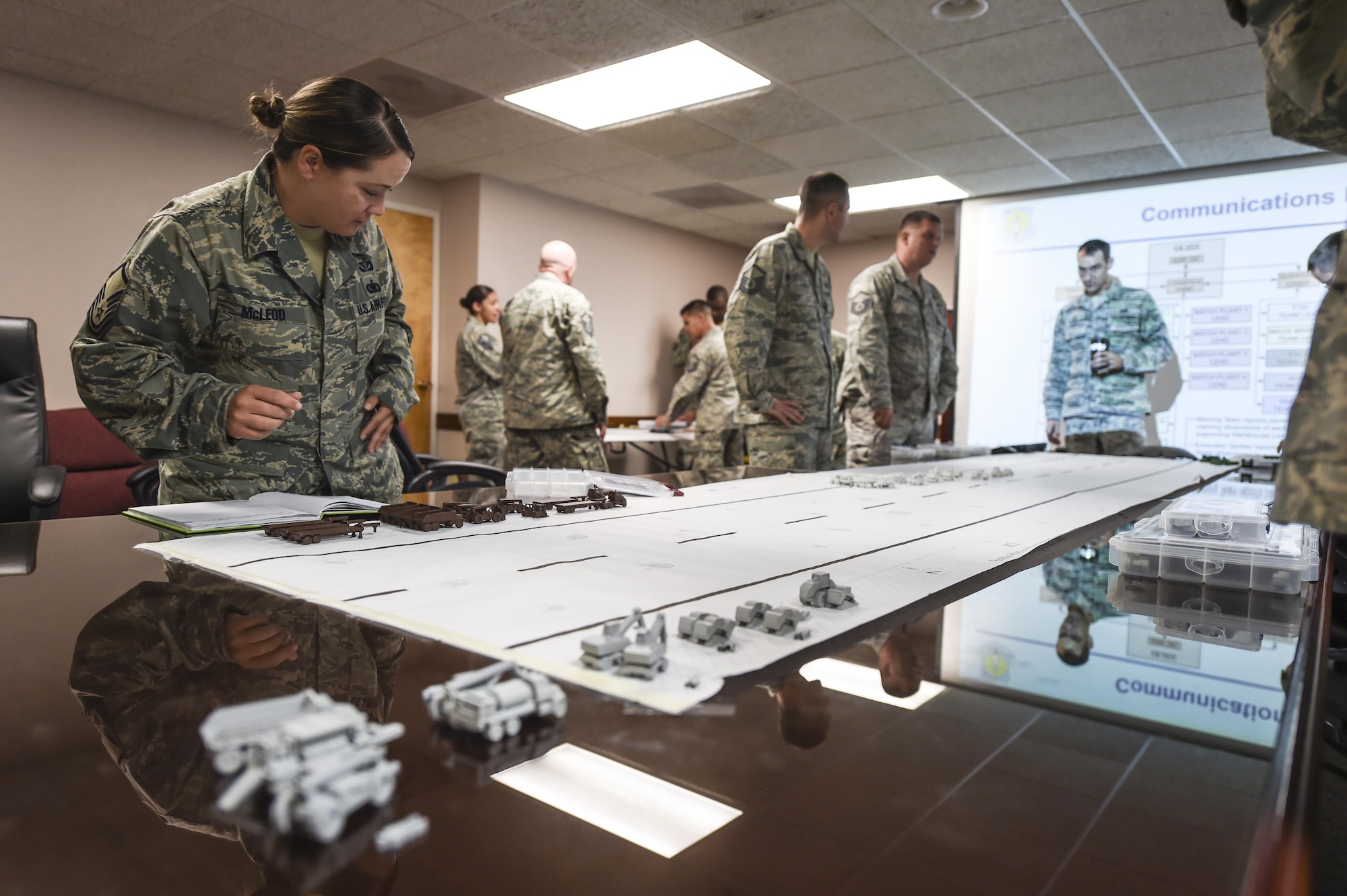 Master Sgt. Shannon, Non-commissioned officer in charge of planning, 49th Civil Engineer Squadron sets pieces of equipment on a simulated run way during the Rapid Airfield Damage Repair Modernization table top exercise at Holloman Holloman Air Force Base N.M. on June 27. Member from the RADR team visited the 49th CES to implement the second part of a four phase training program for runway repair during and after an enemy attack. Mobile training teams will make their way to every Air Force Active Duty, Guard and Reserve installation to teach civil engineers RADR techniques. Over the next few years, this training will be implemented at all Civil Engineering Silver Flag training sites. (Last names withheld due to operational requirements. U.S. Air Force Photo by Staff Sgt. Stacy Moless)