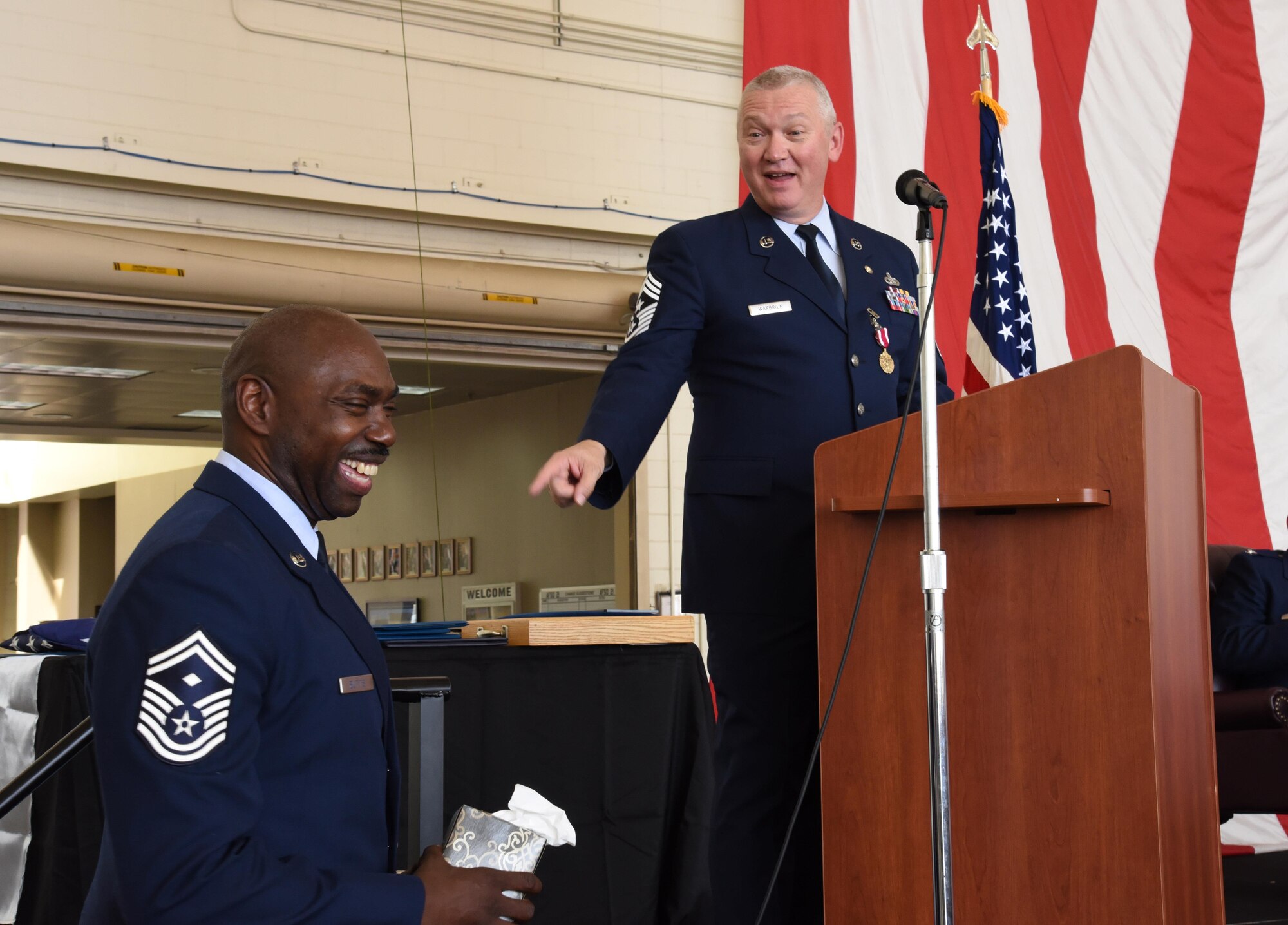 Senior Master Sgt. Charles Butts, first sergeant stands ready to give Chief Master Sgt. Kevin Warbrick, tissues during his retirement ceremony held Sunday here. After serving 33 years of military service, the 514th Air Mobility Wing command chief shared a few memories with the attendees that brought a tear or two his eyes.