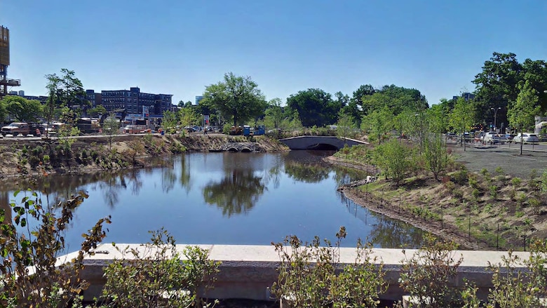Brookline Avenue Culvert at the former Sears Parking Lot, with river diversion sheeting removed and plantings on the banks of the constructed FRM channel.