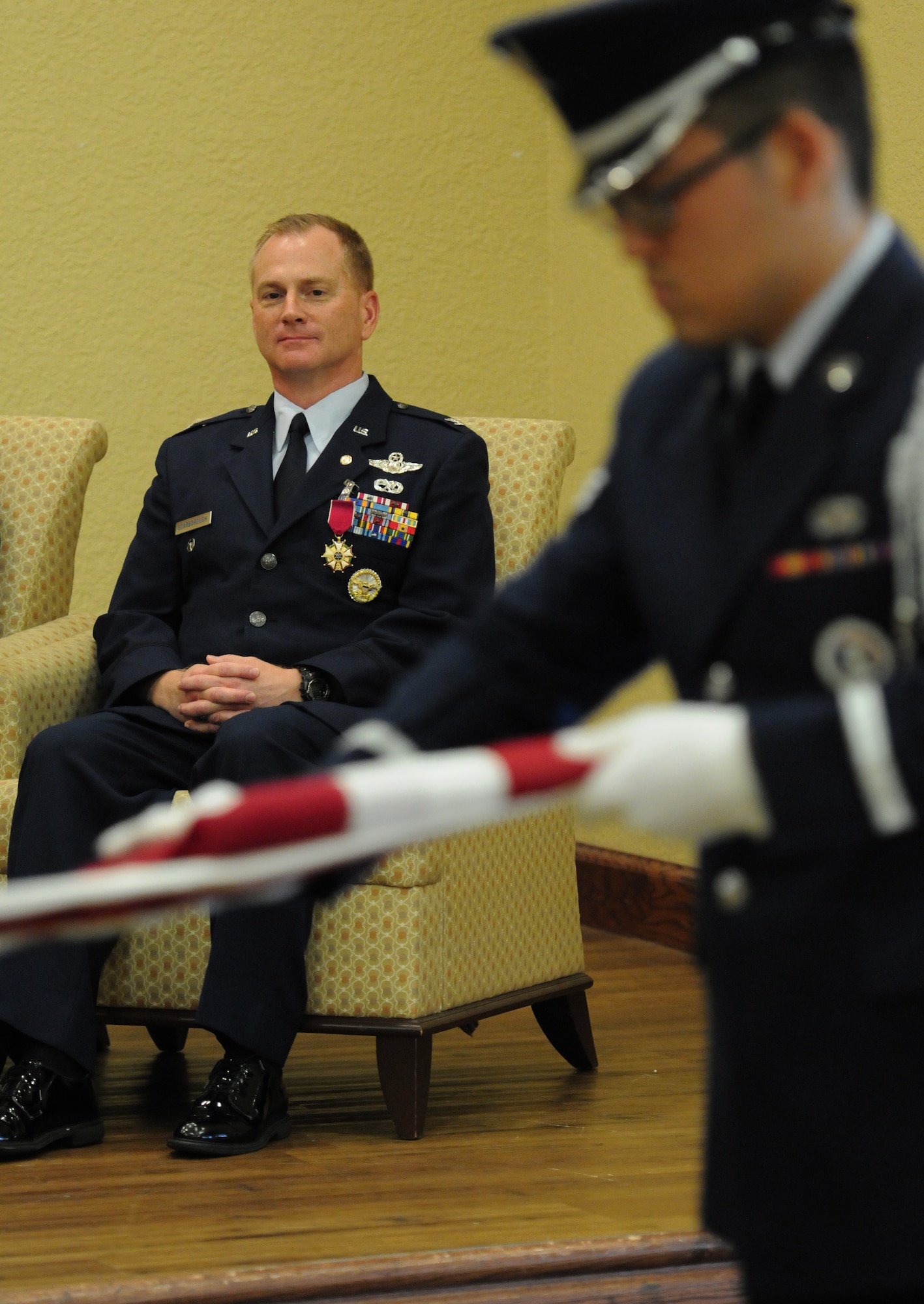 Col. Dennis Scarborough, 81st Training Wing vice commander, watches as the Keesler Honor Guard folds the U.S. flag during his retirement ceremony at the Bay Breeze Event Center June 28, 2016, on Keesler Air Force Base, Miss. Scarborough retired with 27 years of military service. He has served multiple tours as an F-15C instructor and evaluator and has held positions in the fields of defense policy, operational plans, safety and aircraft maintenance. He has commanded at the squadron level and served as an operations group deputy commander. (U.S. Air Force photo by Kemberly Groue/Released)