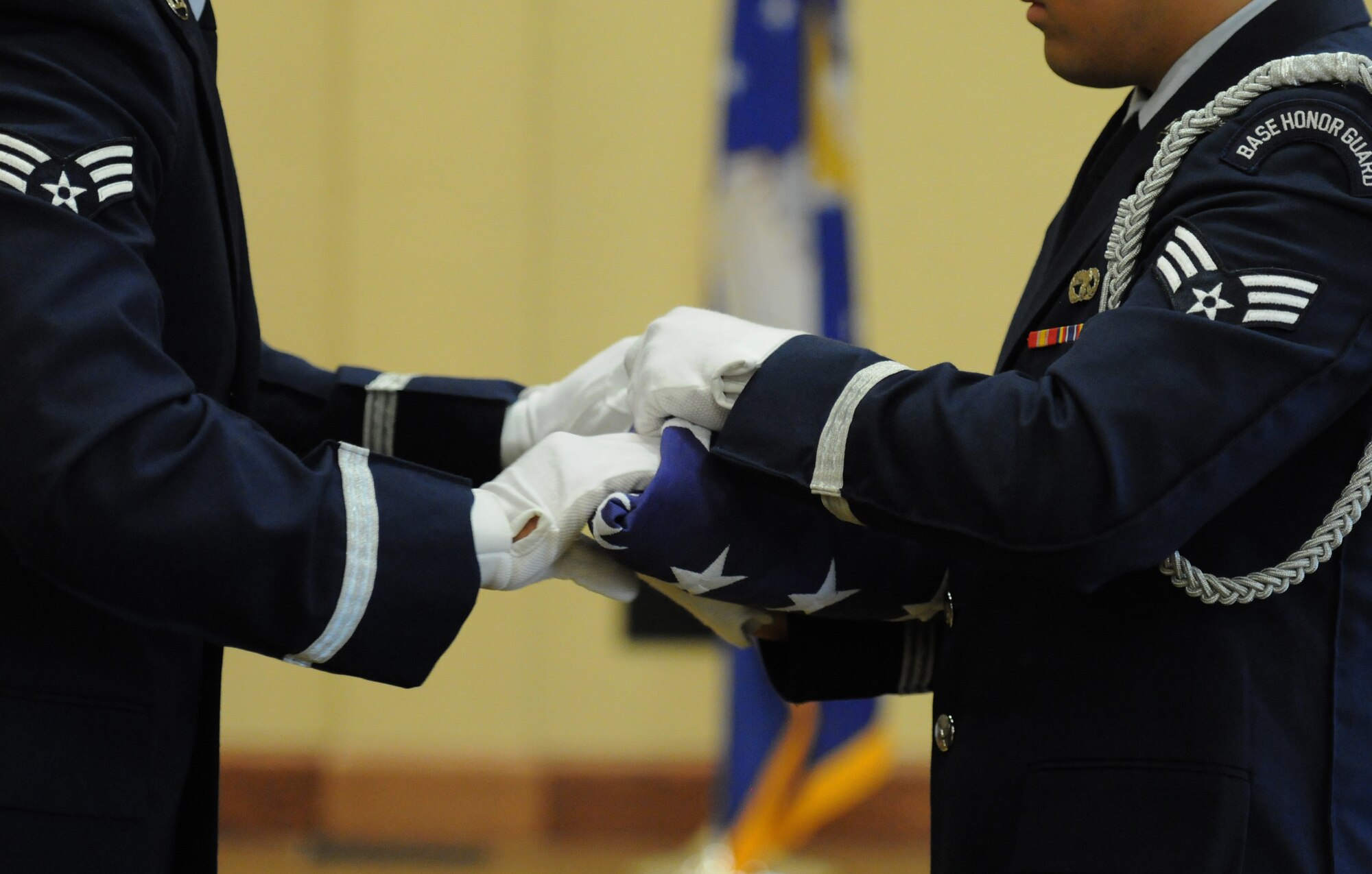 The Keesler Honor Guard folds the U.S. flag during the retirement ceremony for Col. Dennis Scarborough, 81st Training Wing vice commander, at the Bay Breeze Event Center June 28, 2016, on Keesler Air Force Base, Miss. Scarborough retired with 27 years of military service. He has served multiple tours as an F-15C instructor and evaluator and has held positions in the fields of defense policy, operational plans, safety and aircraft maintenance. He has commanded at the squadron level and served as an operations group deputy commander. (U.S. Air Force photo by Kemberly Groue/Released)