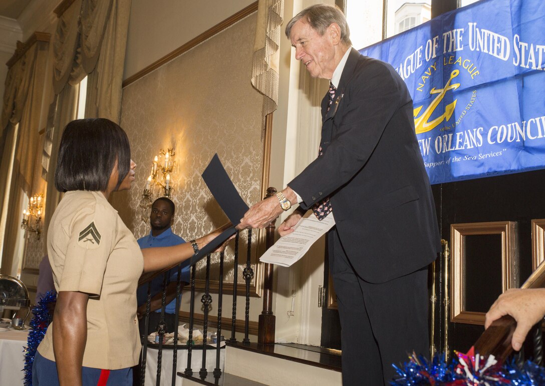 Cpl. Shereka K. Slater (left), an administrative specialist with Marine Forces Reserve Installation Personnel Administration Center, receives the Marine of the Year Award from Tommy Lind (right), the president of the Navy League of the United States Greater New Orleans Council, at “A Taste’n Toast to Our Armed Services” event at the Bourbon Orleans Hotel, New Orleans, July 30, 2016. The award was presented to Slater for her outstanding service to MARFORRES. The Navy League is comprised of 40,000 civilians in more than 240 councils around the world working to support sea service members and their families. (U.S. Marine Corps photo by Sgt. Ian Leones/Released)