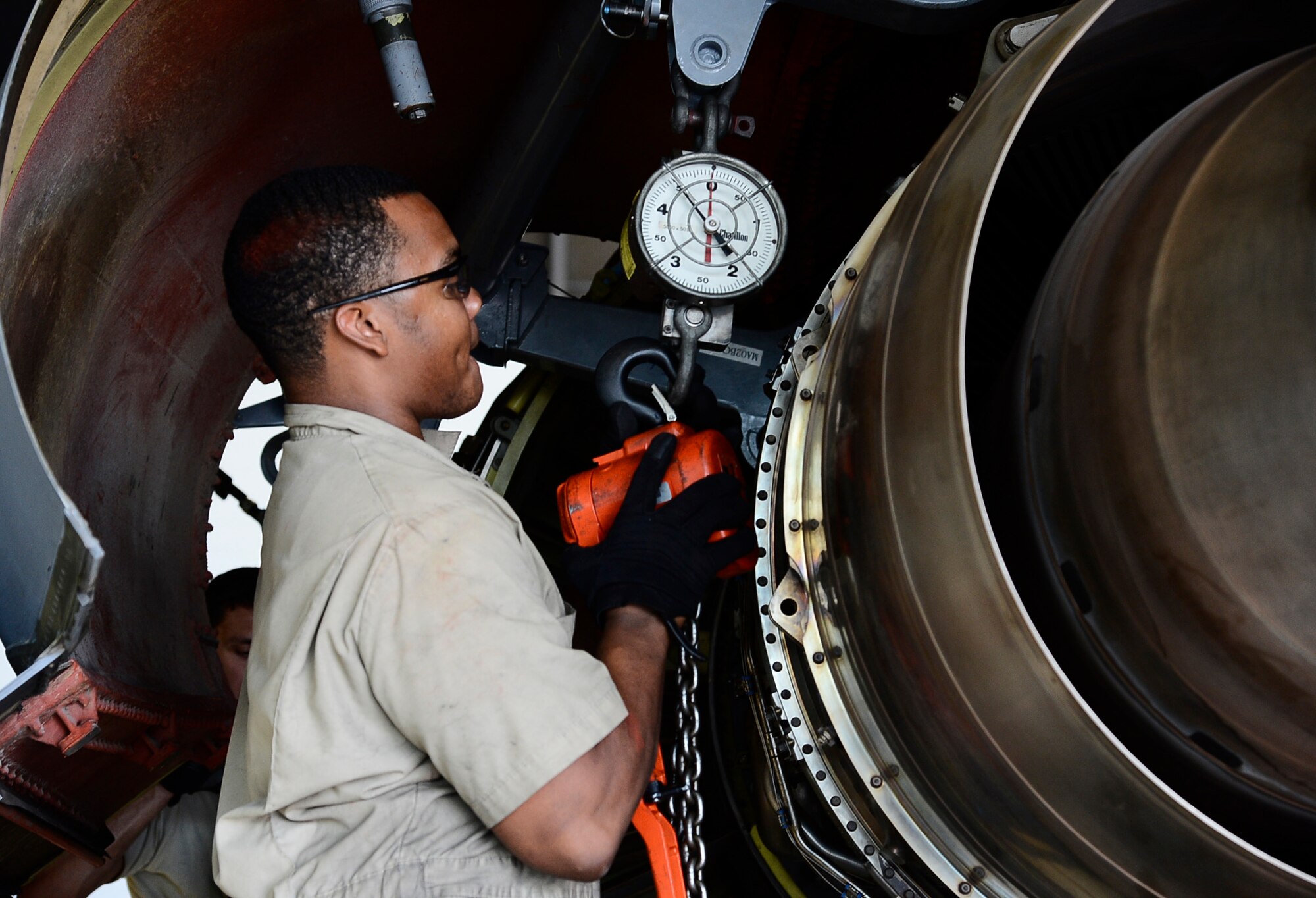 Airman 1st Class Blake Bennett, an aerospace propulsion journeyman assigned to the 6th Maintenance Squadron, hangs a chain hoist on a dynamometer before removing engine one on a KC-135 Stratotanker at MacDill Air Force Base, Fla., June 28, 2016. Dynamometers are used to measure the amount of weight on an engine trailer when removing and installing an engine. The inspection was conducted to ensure the aircraft was mission ready after a hard landing. (U.S. Air Force photo by Senior Airman Tori Schultz)