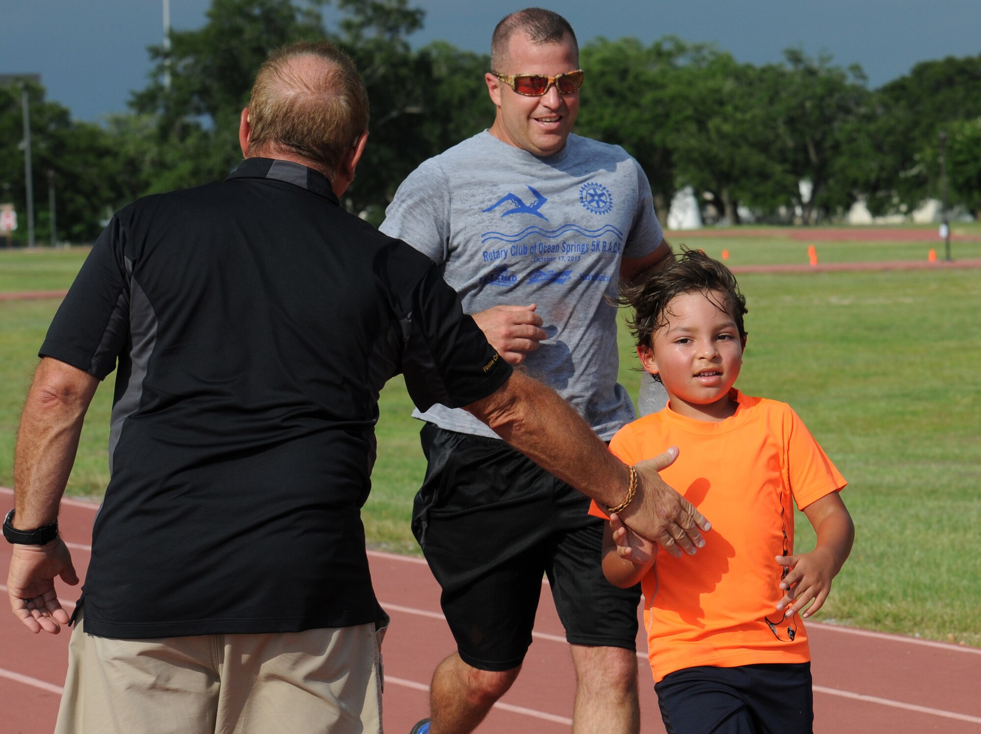 Chief Master Sgt. Derek Fromenthal, 338th Training Squadron superintendent, and his son, D’Anthony, complete a one-mile run and obstacle course during the Obstacle Warrior Dash 5K at the Triangle track June 27, 2016, on Keesler Air Force Base, Miss. The 81st Force Support Squadron-sponsored event involved participants completing a 5K run then making their way through eight different obstacles. (U.S. Air Force photo by Kemberly Groue/Released)