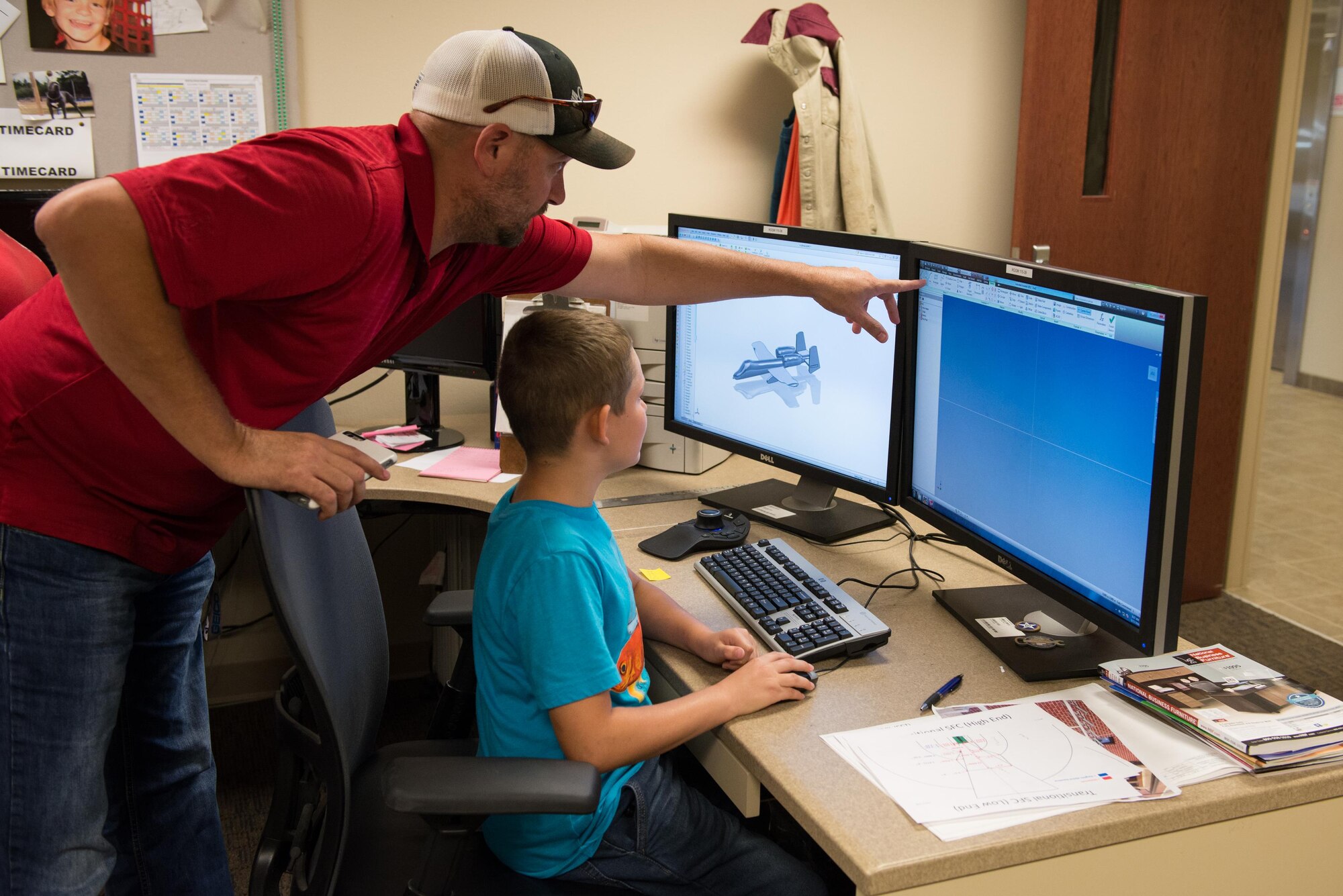 Heath Harris, 81st Training Support Squadron technical engineer, demonstrates computer design software to a student from the Science, Technology, Engineering, and Mathematics  Camp June 23, 2016, on Keesler Air Force Base, Miss. Keesler partnered with the Biloxi School District, Biloxi, Miss. in a week-long summer program designed to educate and enrich middle school students interested in science, technology, engineering or mathematics. (U.S. Air Force photo by Marie Floyd/Released)