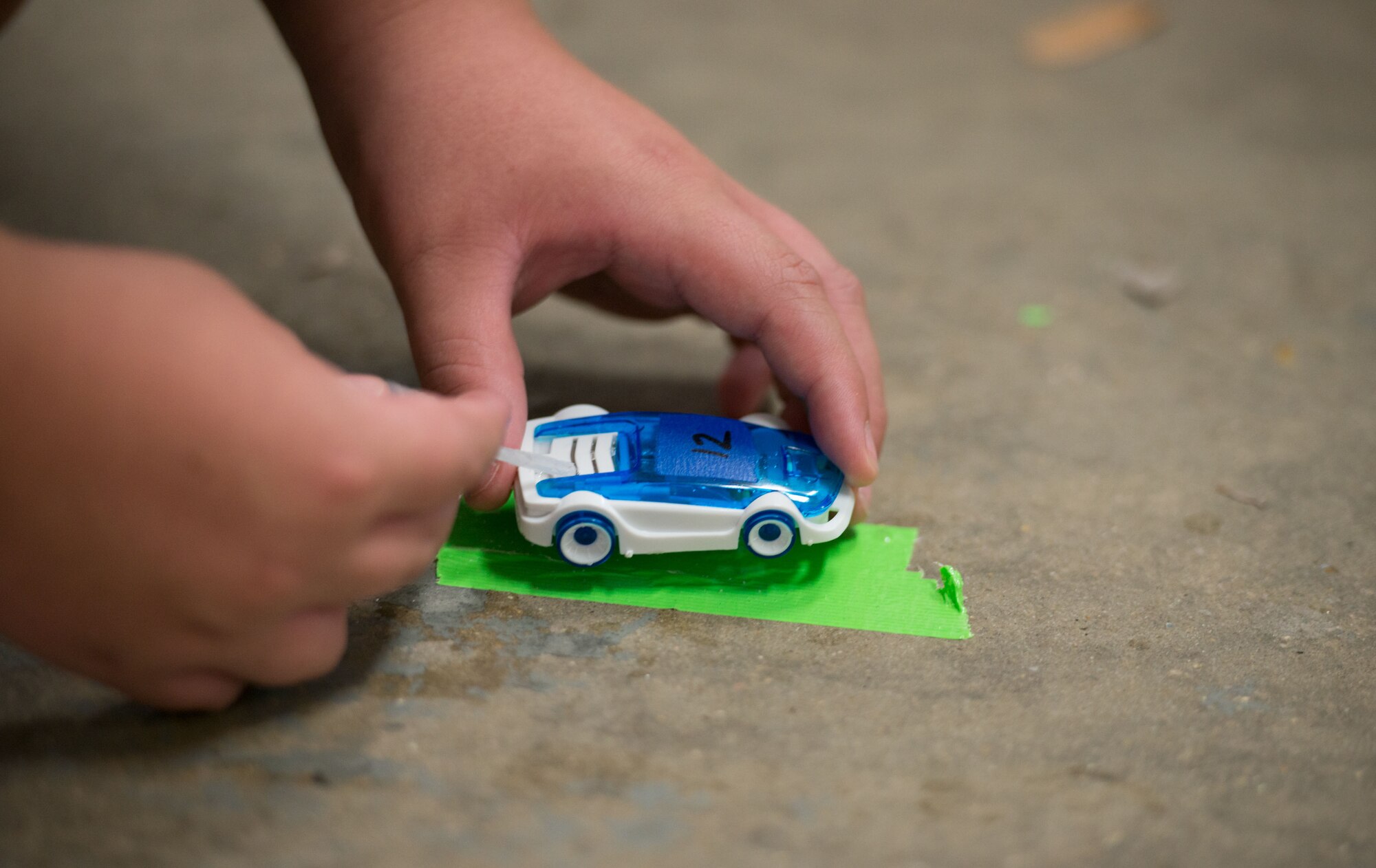 A Science, Technology, Engineering, and Mathematics camp student injects water into a salt water fuel cell toy car at Biloxi Junior High School, Biloxi, Miss. on June 24, 2016. Keesler instructors educated students about new forms of clean energy during a week-long program for fifth, sixth, and seventh graders who are interested in science, technology, engineering or mathematics. (U.S. Air Force photo by Marie Floyd/Released)