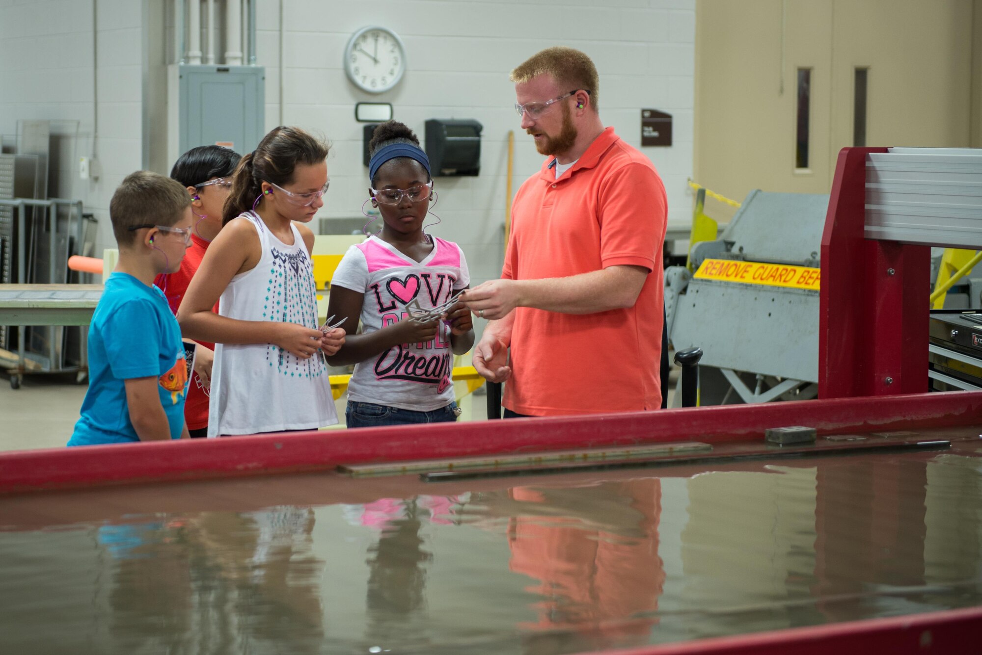 James McCanless, 336th Training Squadron machinist, demonstrates a water-jet cutting machine to Science, Technology, Engineering, and Mathematics Camp students June 23, 2016, on Keesler Air Force Base, Miss. Keesler partnered with the Biloxi School District, Biloxi, Miss. in a week-long summer program designed to educate and enrich middle school students interested in science, technology, engineering or mathematics. (U.S. Air Force photo by Marie Floyd/Released)