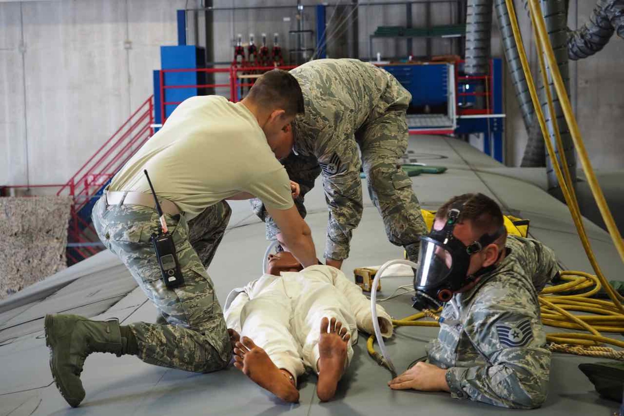 934th Maintenance Squadron members extract a simulated incapacitated person from a C-130 fuel cell.